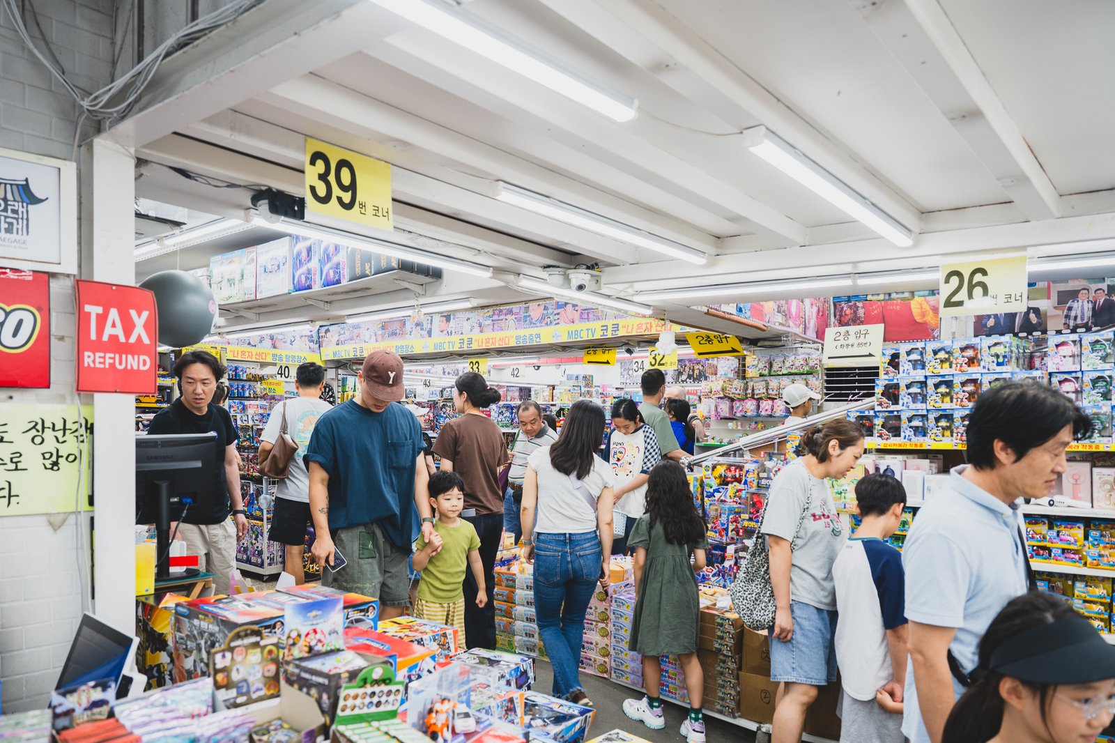 Interior aisles marked with numbered sections like "Corner 39" and "Corner 26," with families browsing between them