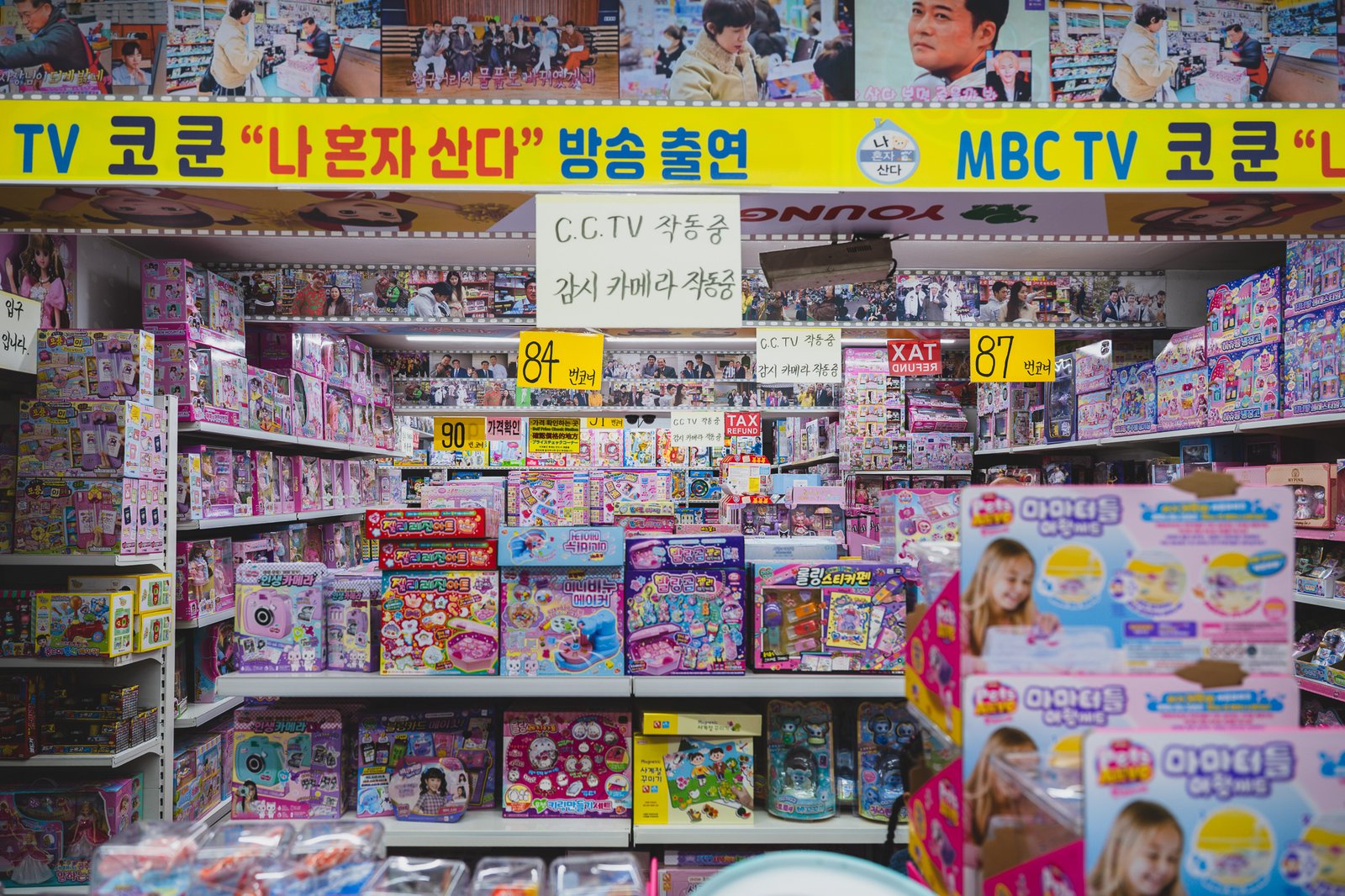 A wall of Tomica and Hot Wheels die-cast miniature cars