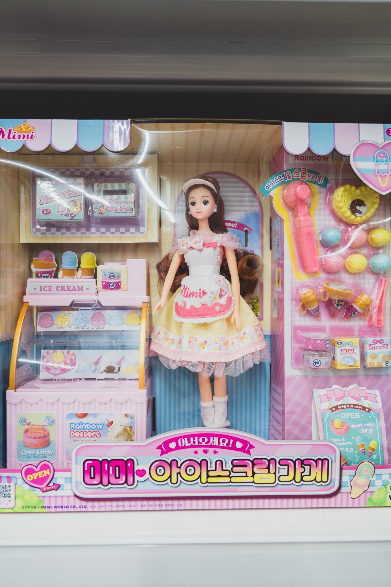 A "Mimi World" dollhouse-style clothing shop playset, packed with tiny outfits and accessories