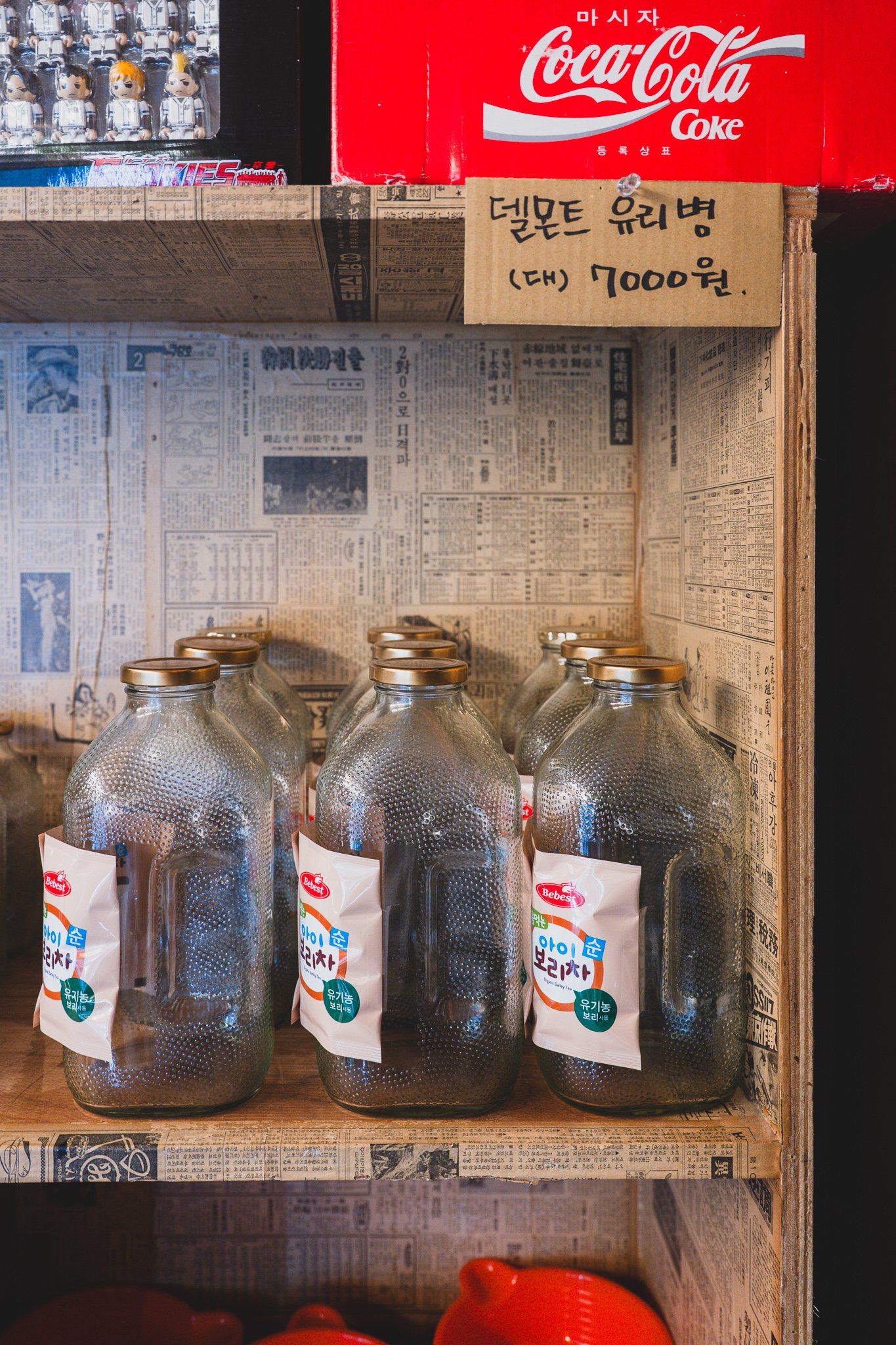 Empty glass Delmonte-style bottles for sale, priced at ₩7,000 for the large size
