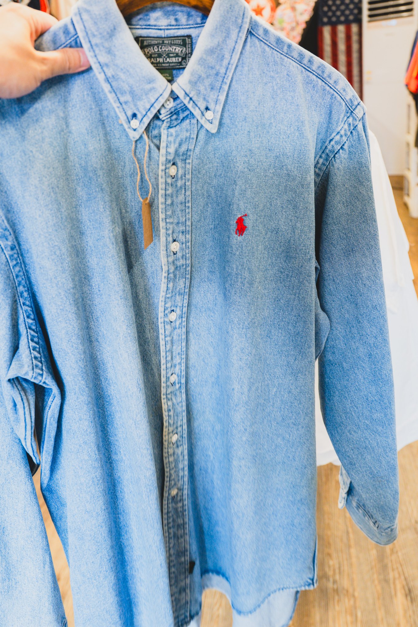 Close-up of a "Polo Country / Ralph Lauren / EST 1967" label on a denim shirt