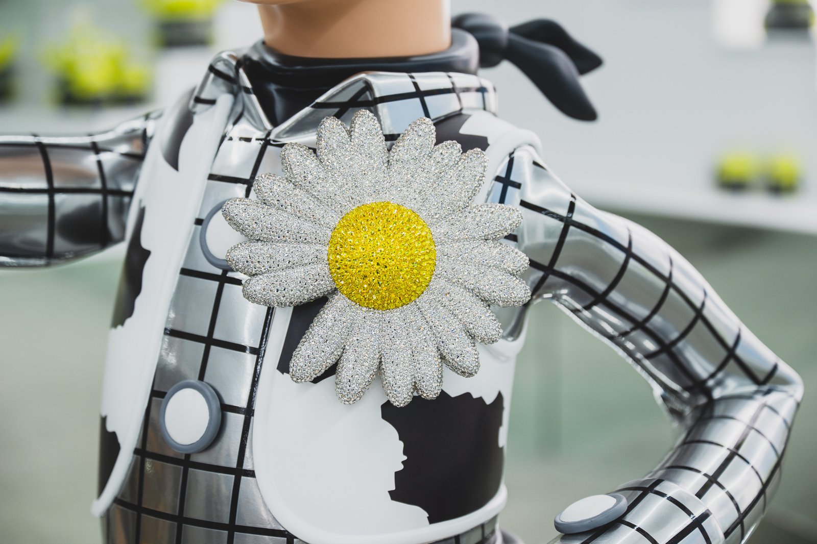 Close-up of the daisy brooch on the life-size Woody figure, packed with thousands of small crystals