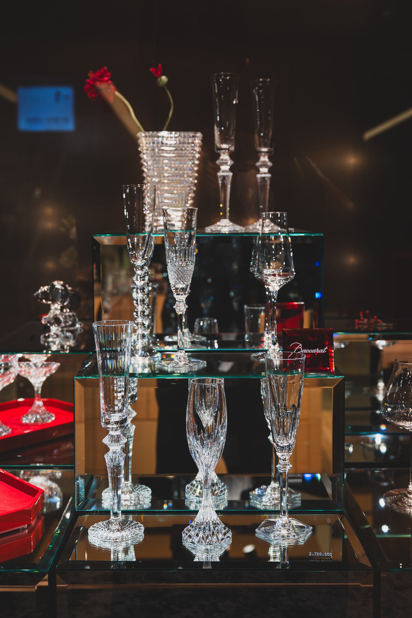 A glass display case of Baccarat crystal stemware and vases, priced at 2,750,000 won