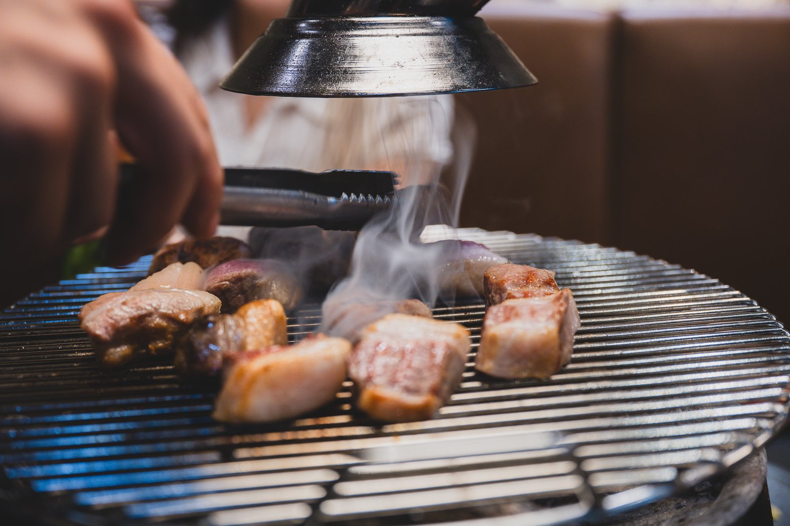 A close-up of two grilled pork cuts, browned and caramelized on the outside