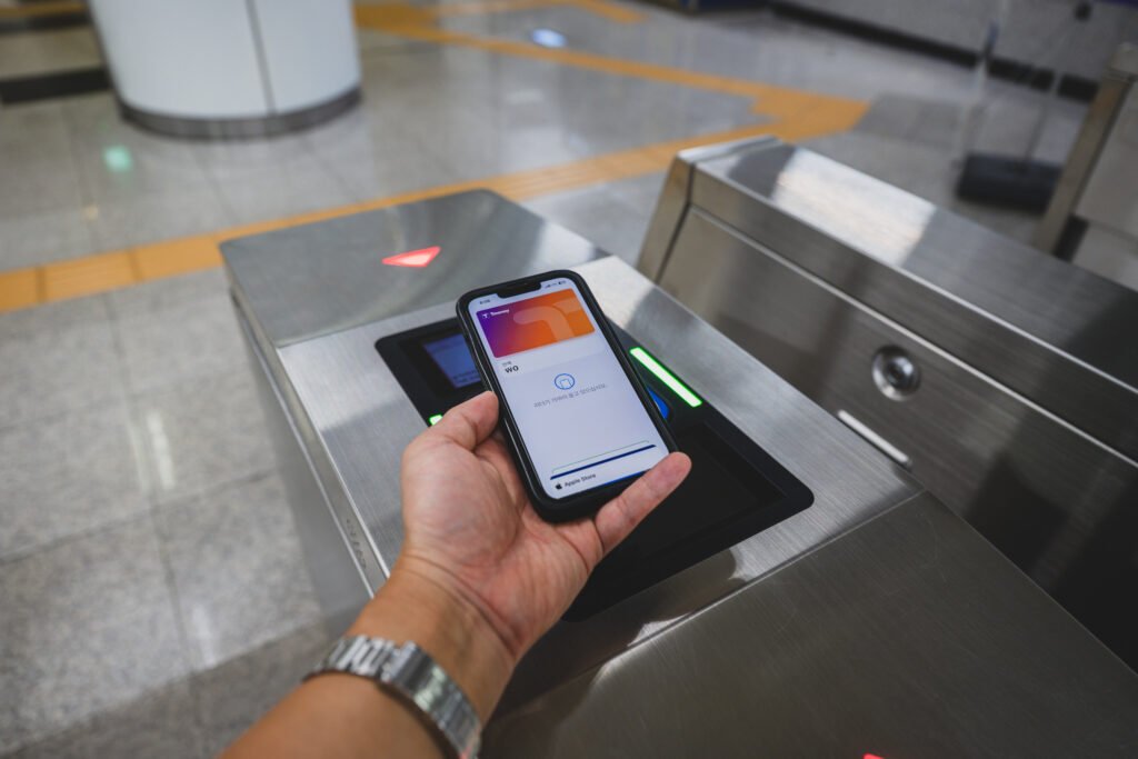 Tagging into a Seoul subway gate with T-money loaded in Apple Pay — just hold the phone near the reader like a physical card, no app needs to be open