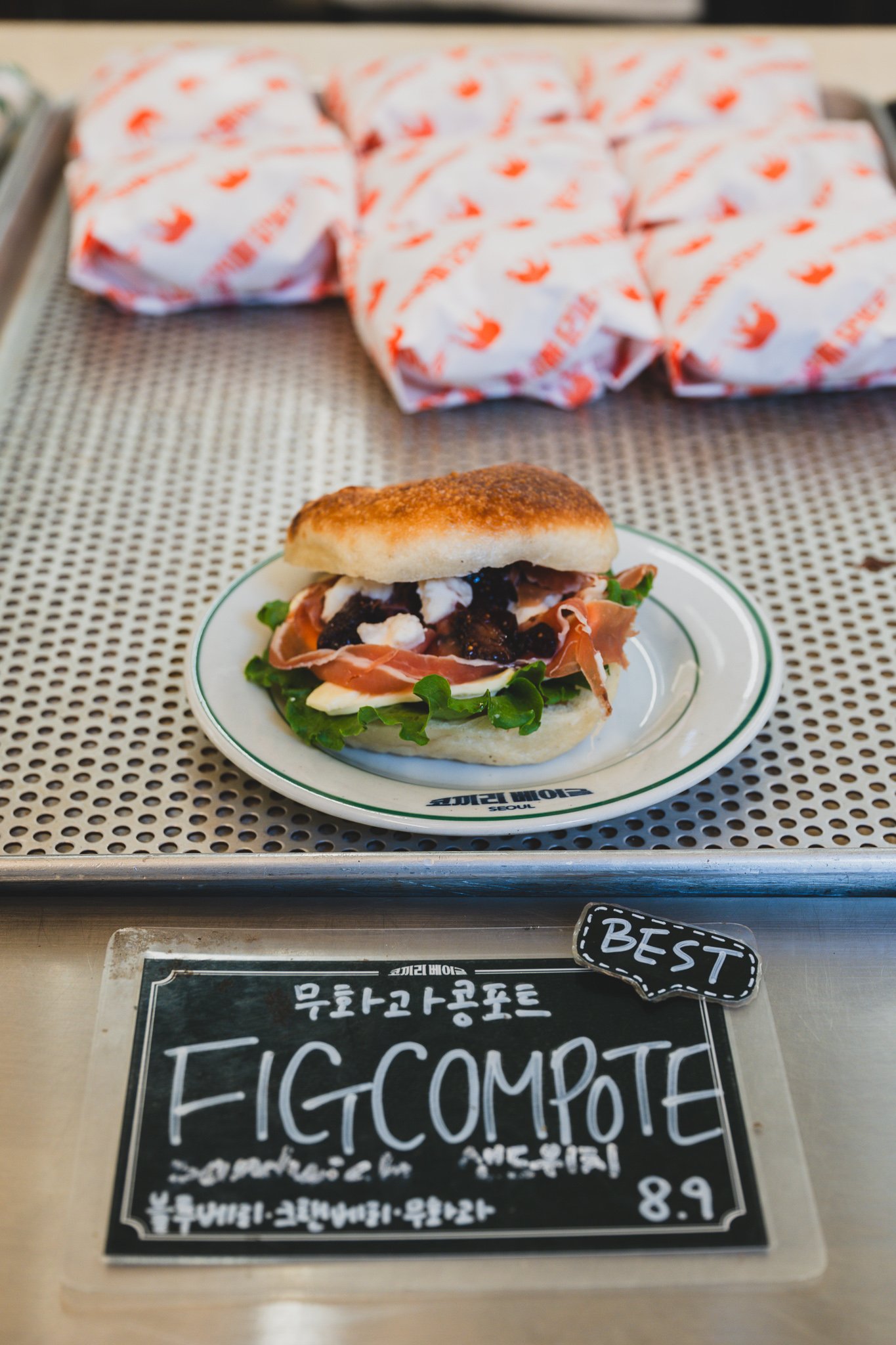 The fig compote sandwich display with a "Best" tag