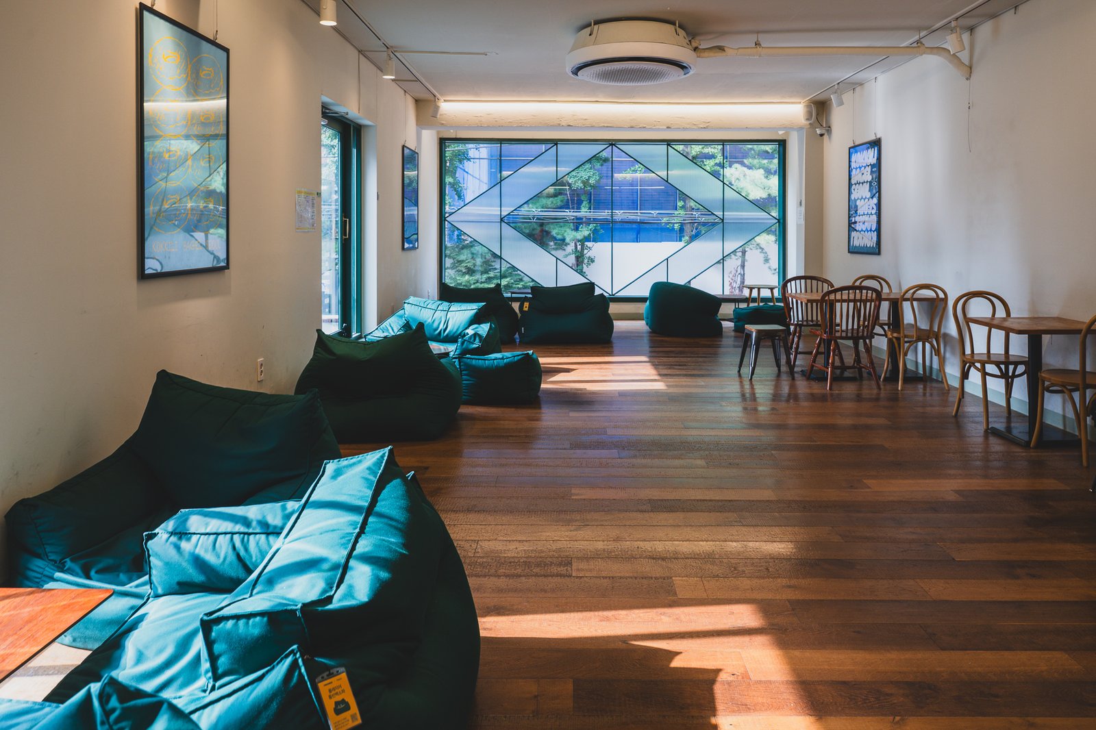 A lounge corner furnished with green beanbag chairs
