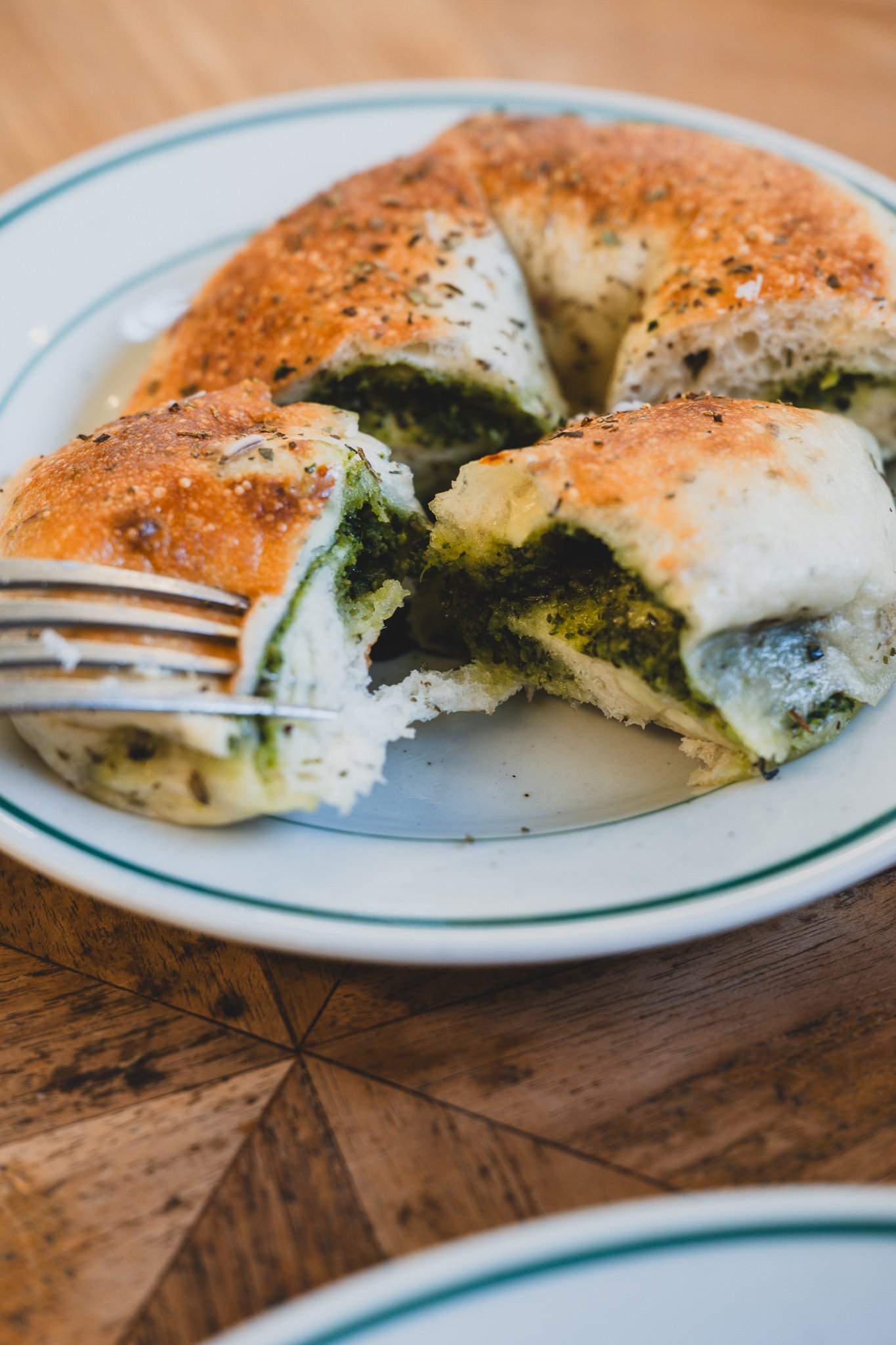 Cross-section of the basil bagel showing the pesto and cheese filling