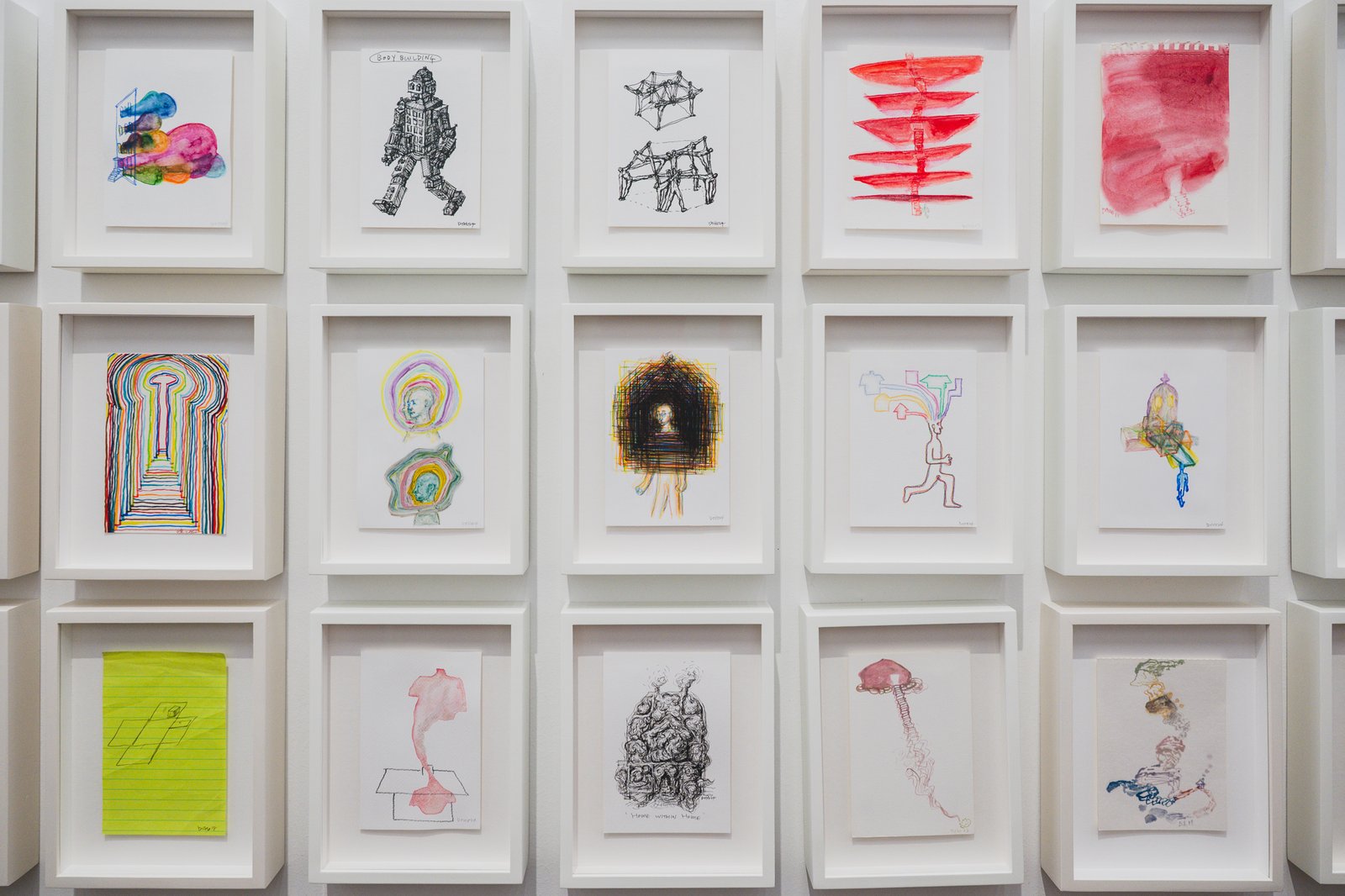 Wall covered in early studies and sketches, from architectural drawings to notebook doodles