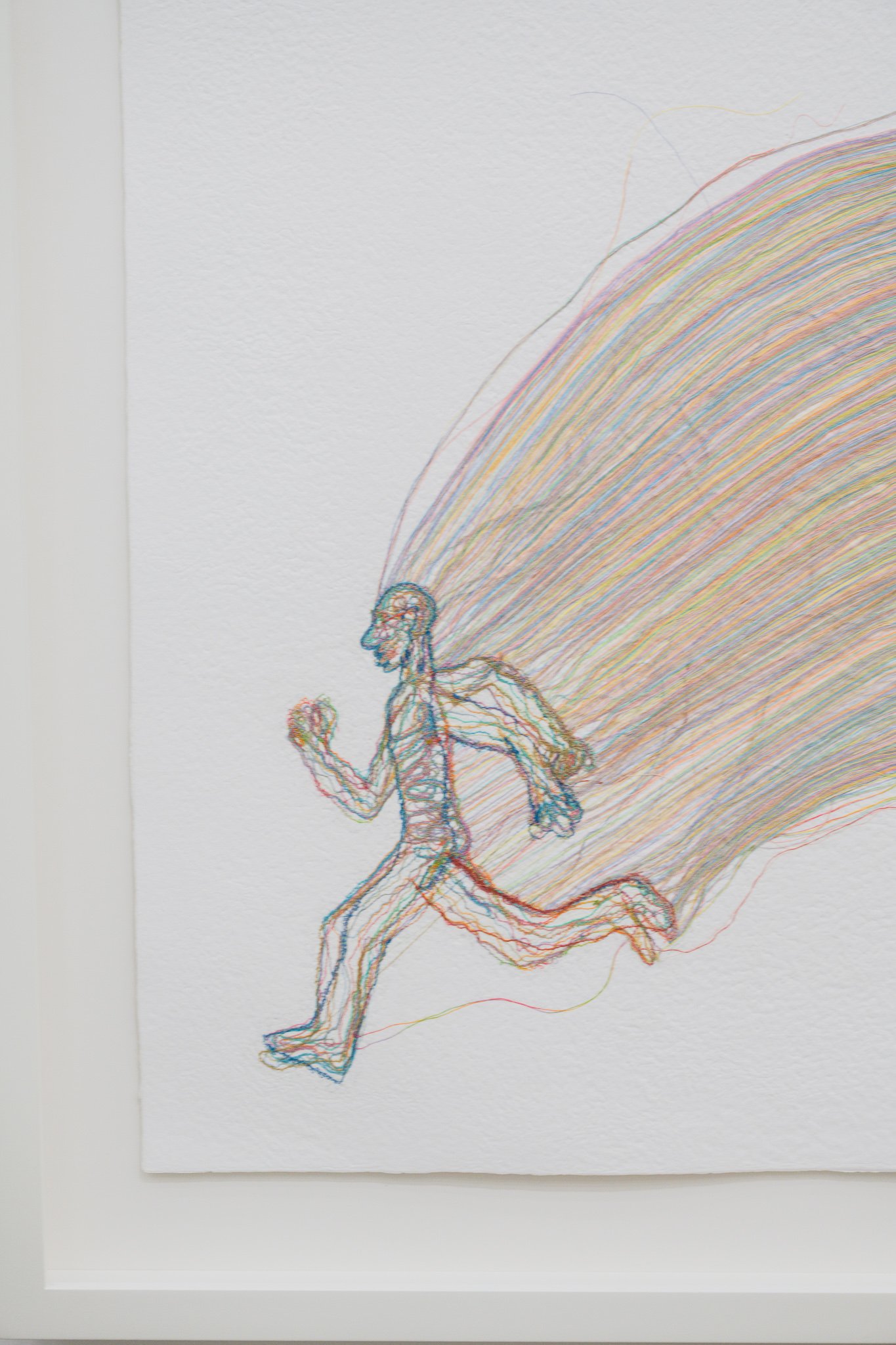 Colorful layered thread silhouette of a running figure, rainbow-colored trailing lines