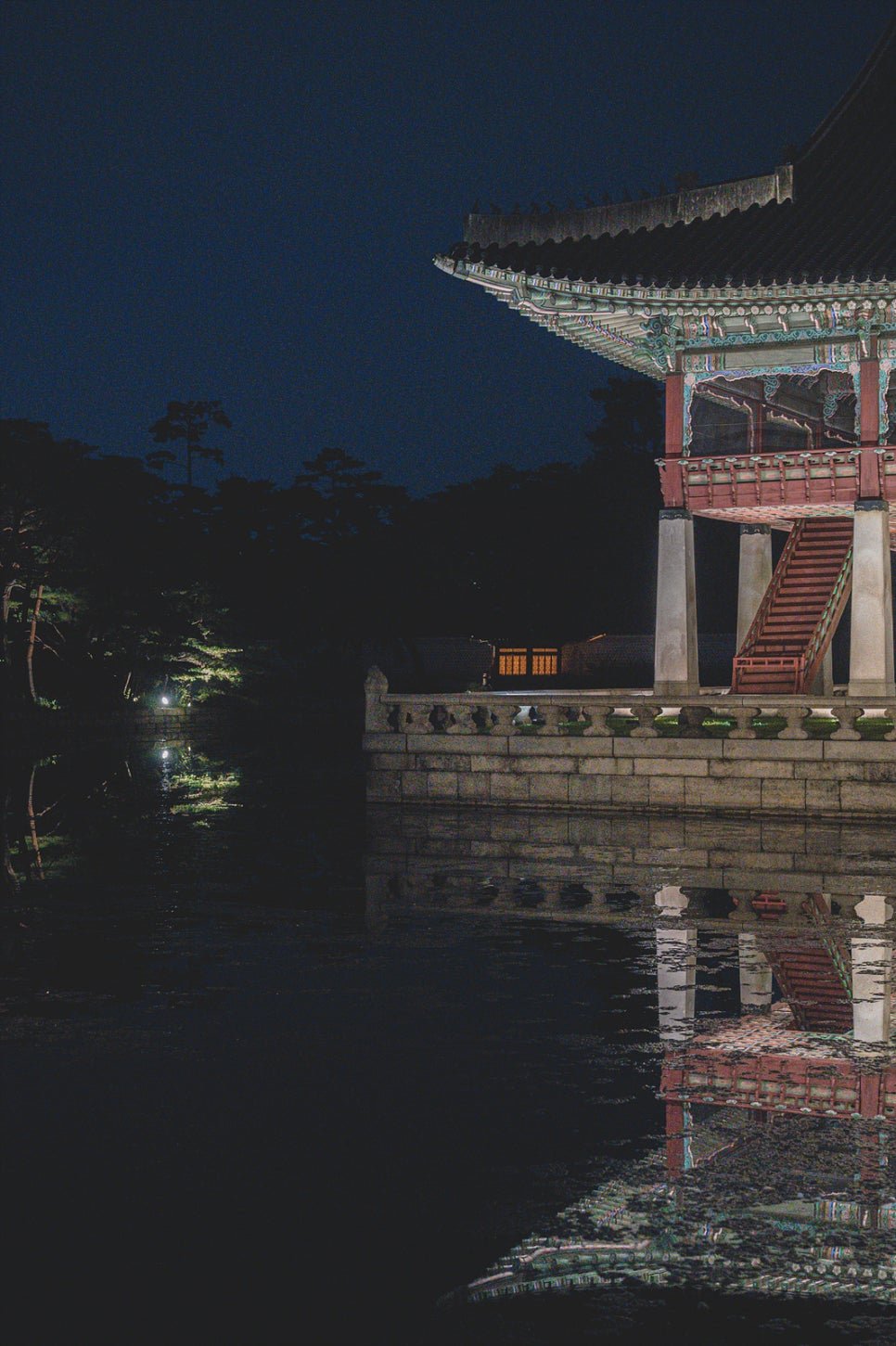 Gyeonghoeru's side staircase and railings reflected in the water below