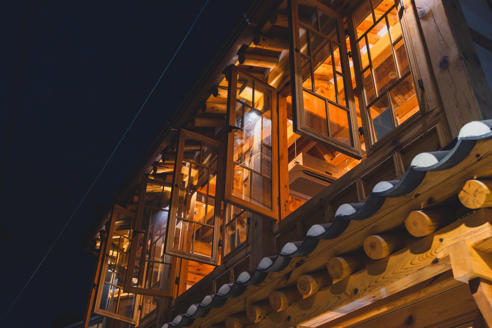 Close-up of the tiled roof and wooden window frames on Yeonggwang Tongdak 2's exterior