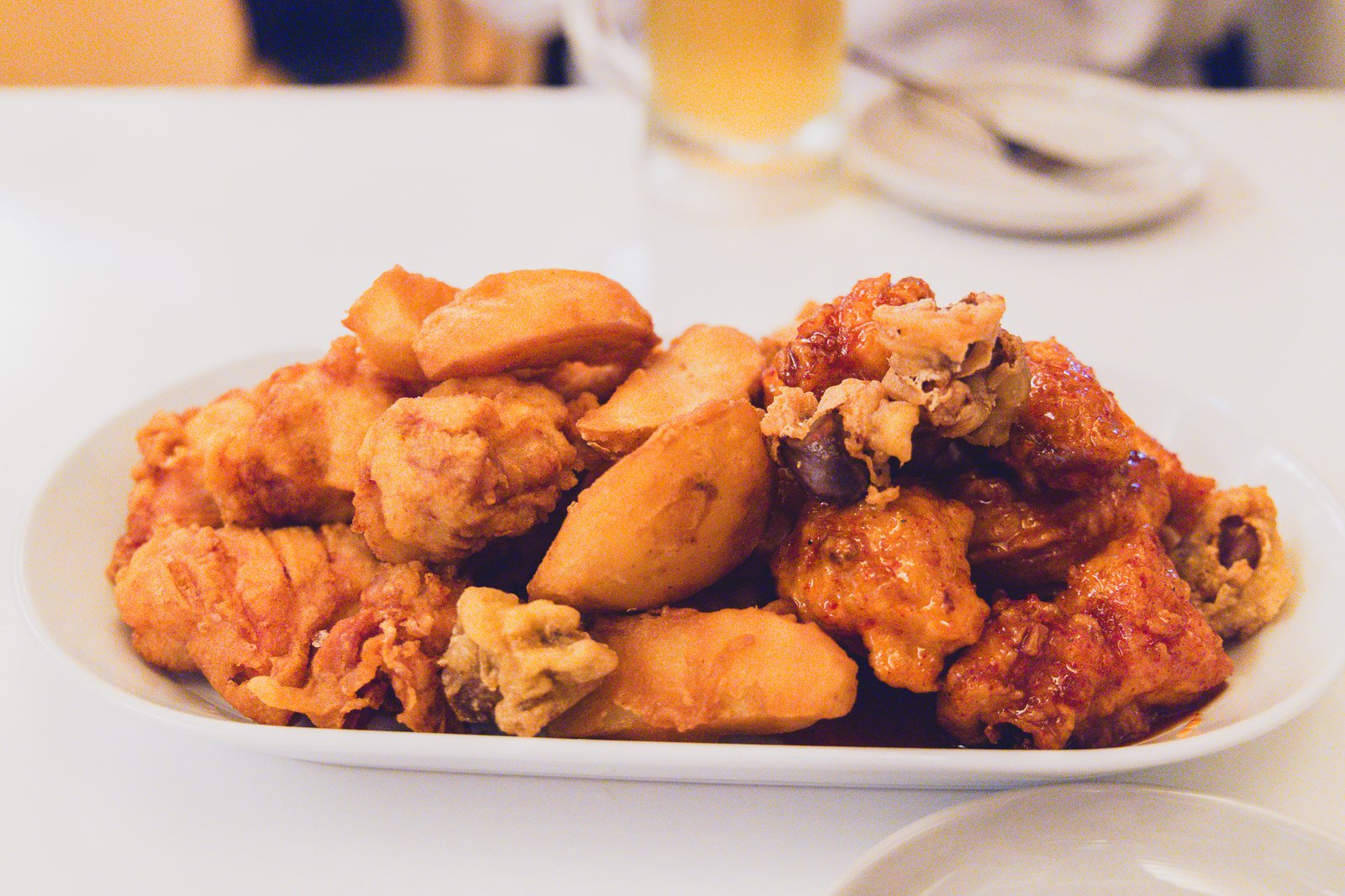 Plate of boneless half-and-half chicken with fries and fried gizzards