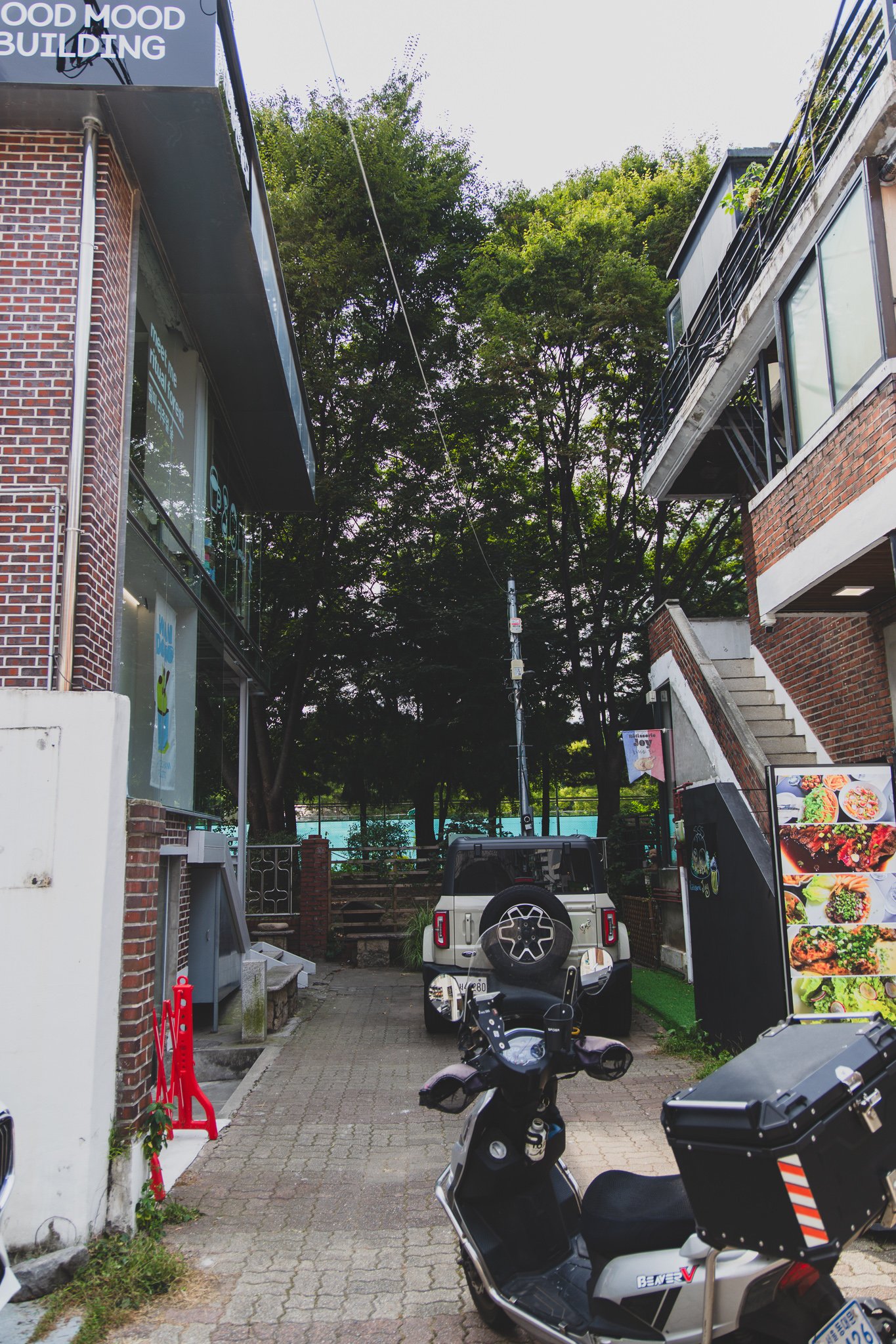 The alley leading toward Good Mood Building, oh lolly day's storefront window visible on the left
