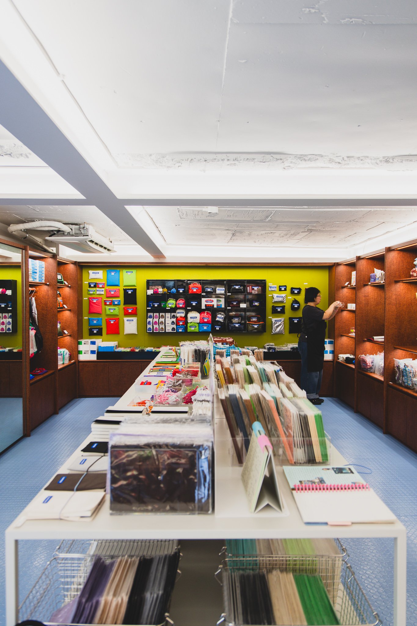 Notebooks, diaries, and pouches organized by category on a display table