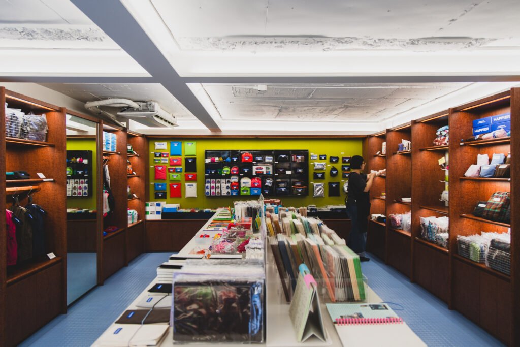 HAPPIER-branded diaries and memo pads displayed alongside a Marshall speaker