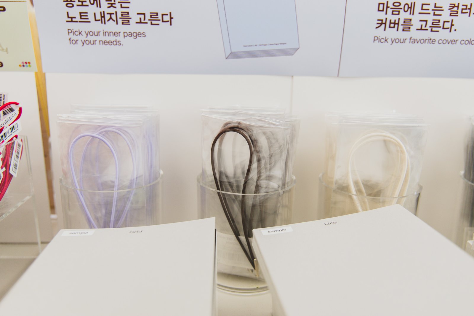 A row of colored strap samples in lavender, black, ivory, and other tones