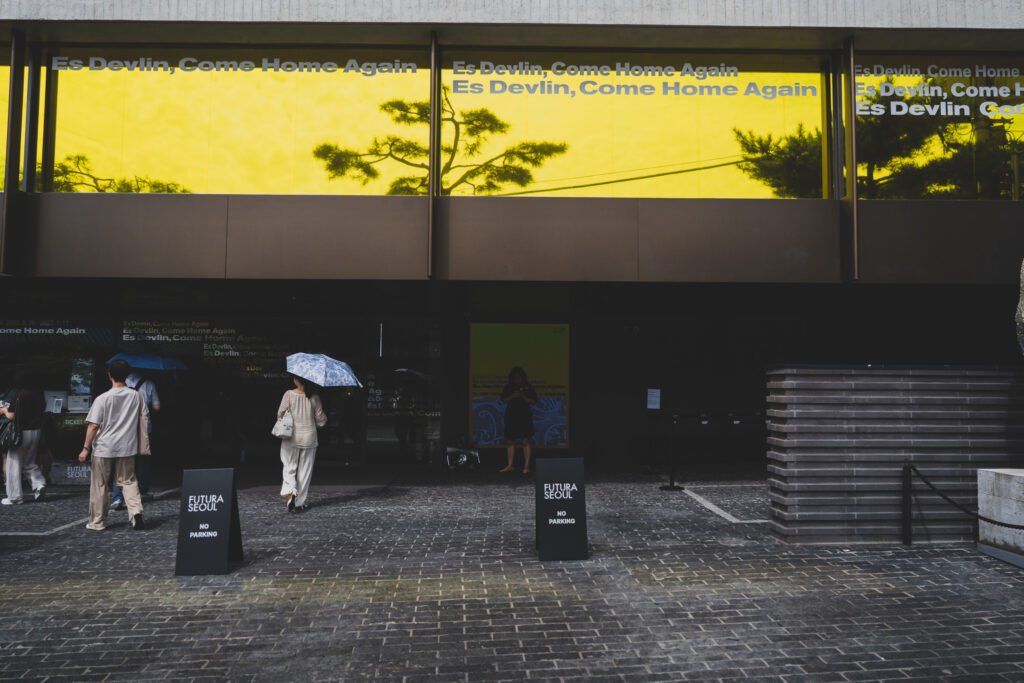 Futura Seoul exterior with "Es Devlin, Come Home Again" signage at the entrance