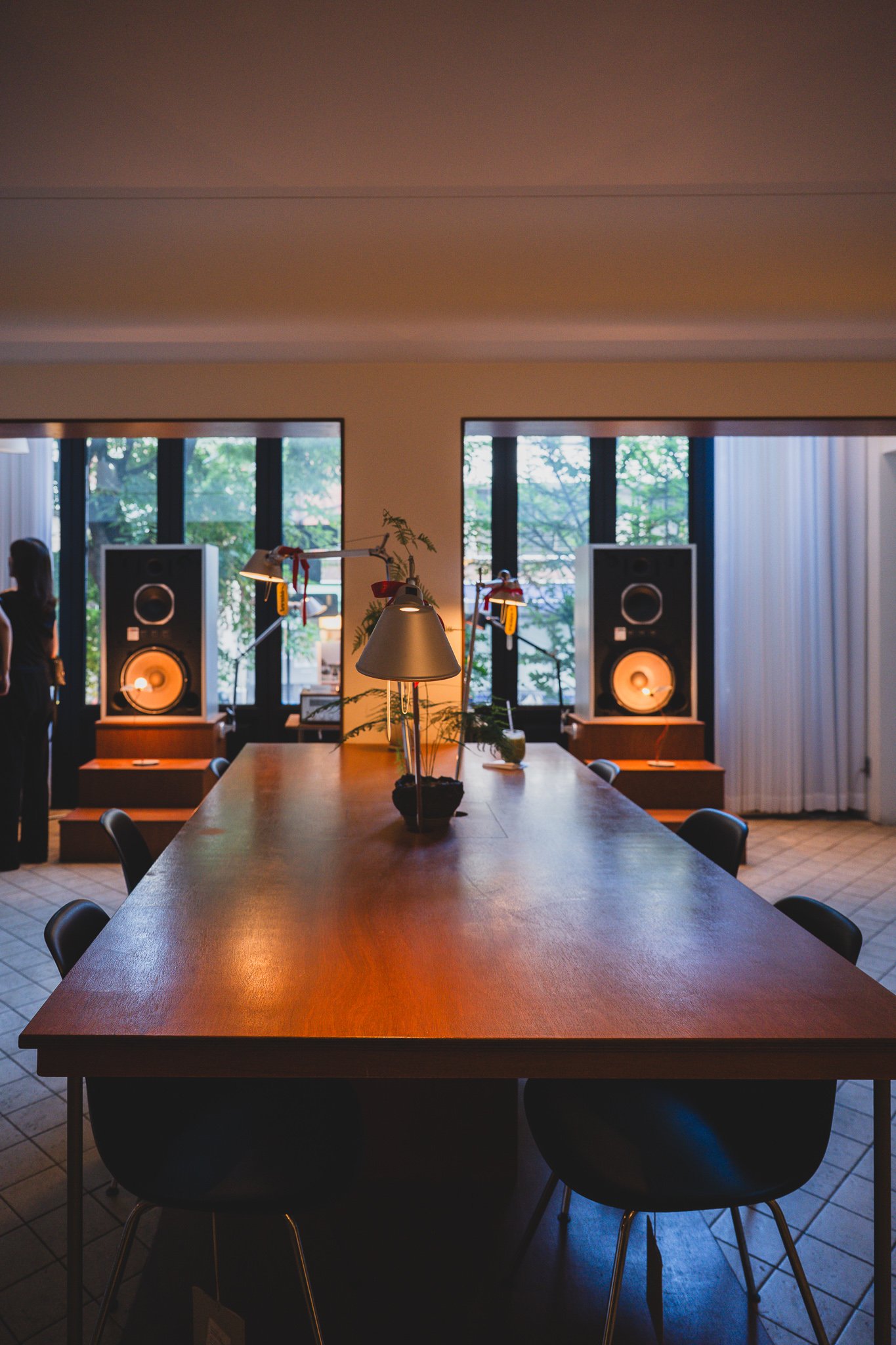 Second seating area with two JBL speakers facing each other, plus a Tolomeo lamp