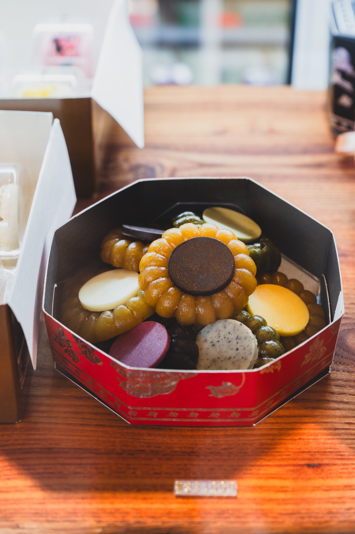Open cookie box revealing round chewy cookies in different colors