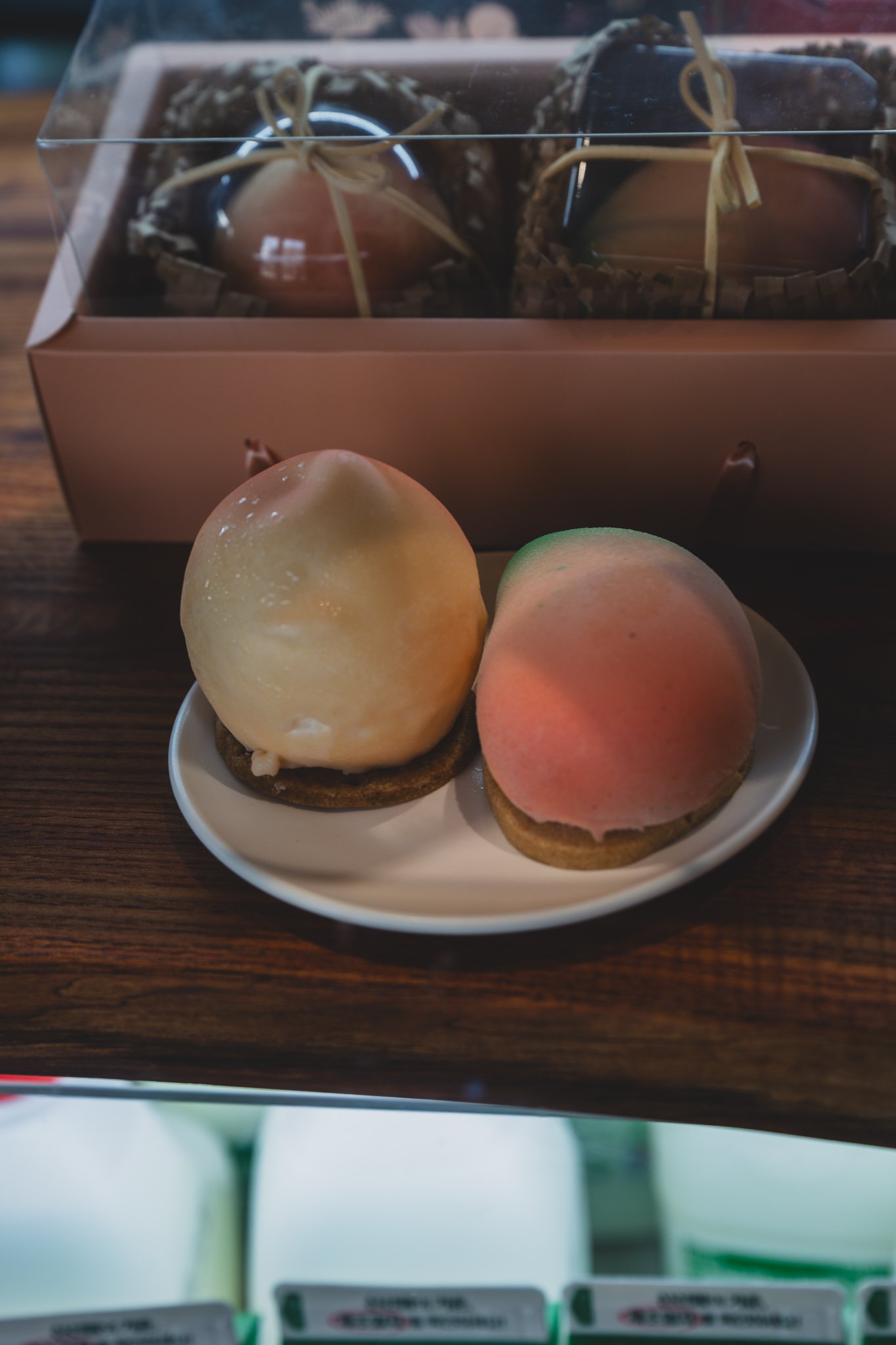 Two Agejak Cakes finished in a peach shape, one cream-colored and one pink