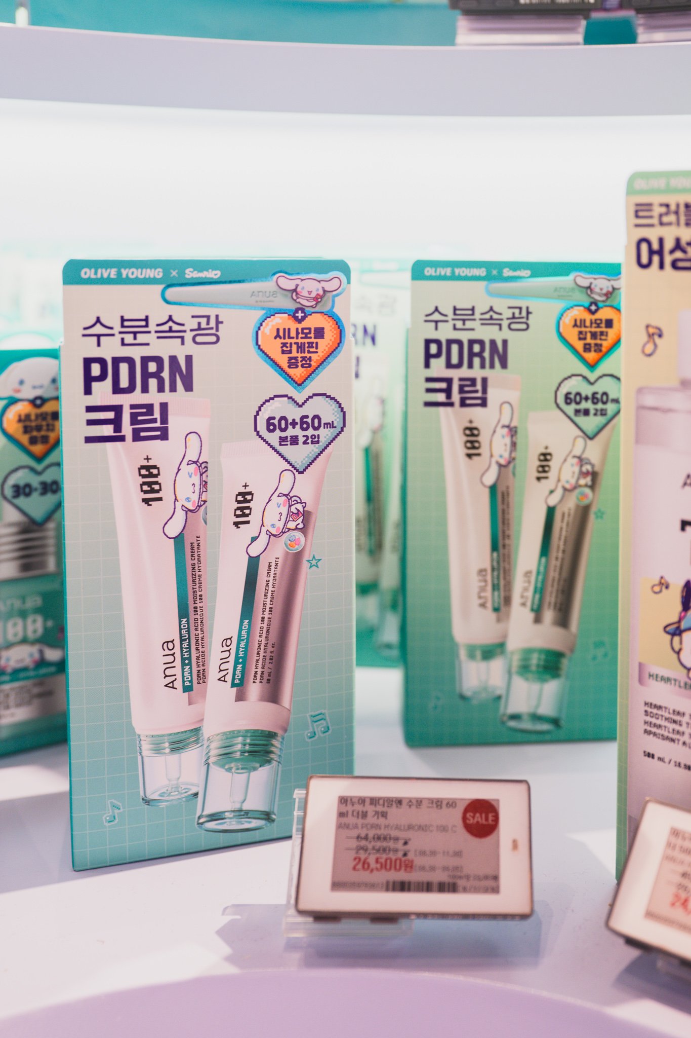Anua PDRN cream in a Sanrio Cinnamoroll-branded box, part of the Olive Young x Sanrio collaboration display