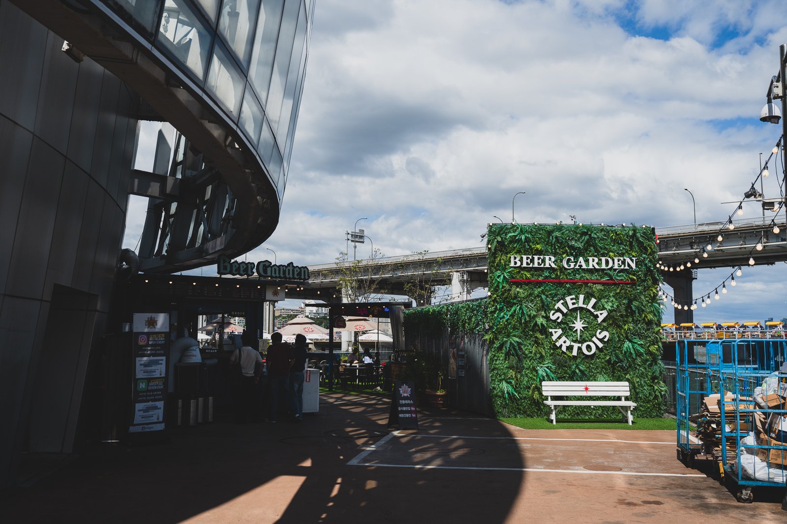 Beer garden entrance with a Stella Artois photo zone against a green plant wall