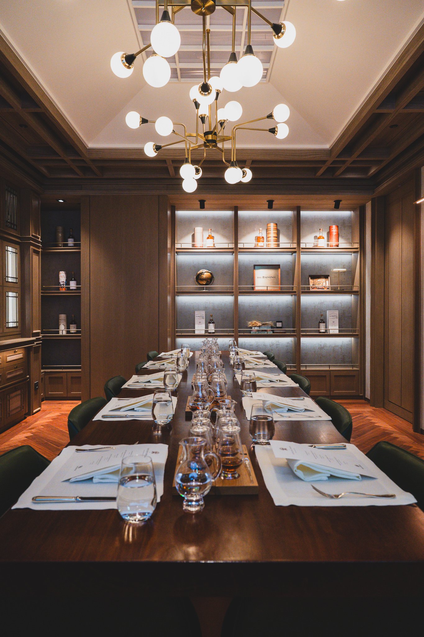 Private dining room with a long table, WILDMOOR branding displayed on a screen