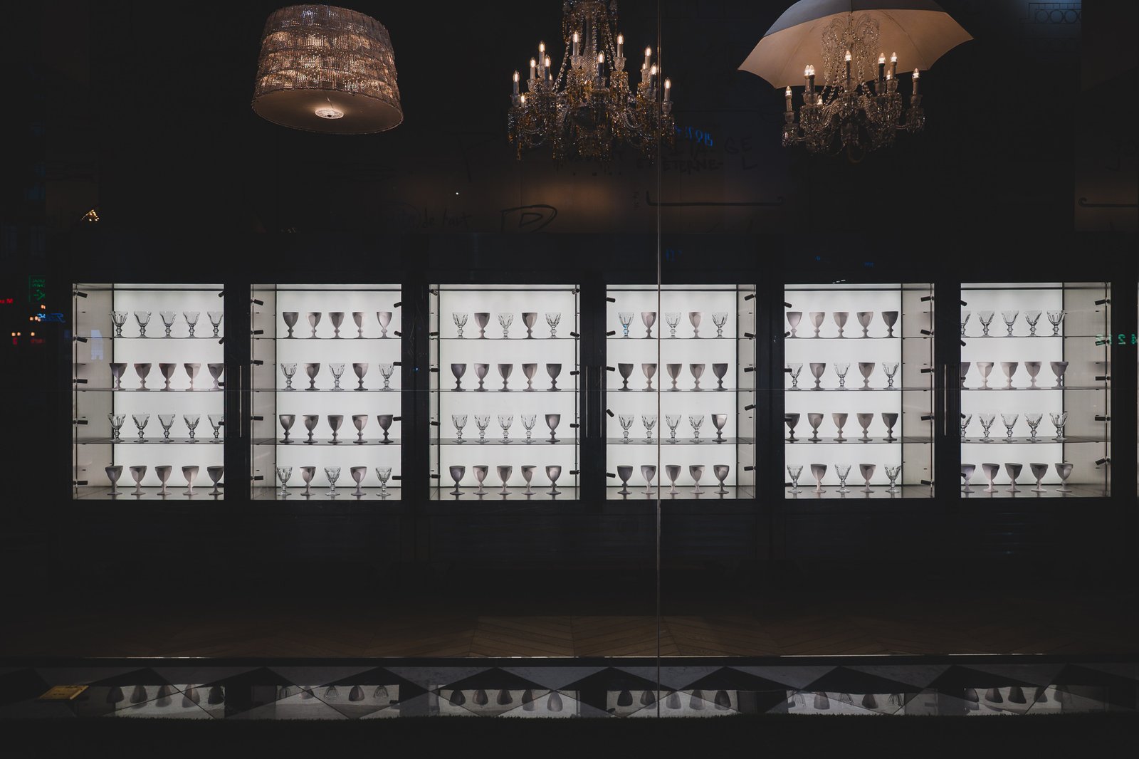 A refrigerator-shaped display case filled with rows of Baccarat's Harcourt 1841 crystal glasses