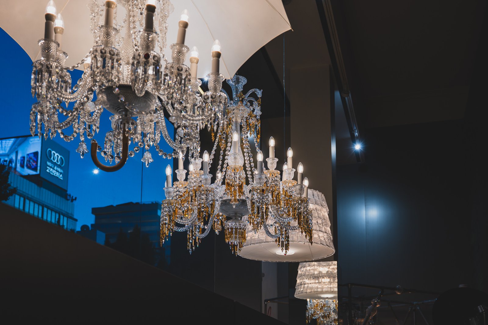 The entrance area of Maison Baccarat Seoul, ceiling filled with an assortment of differently styled crystal chandeliers