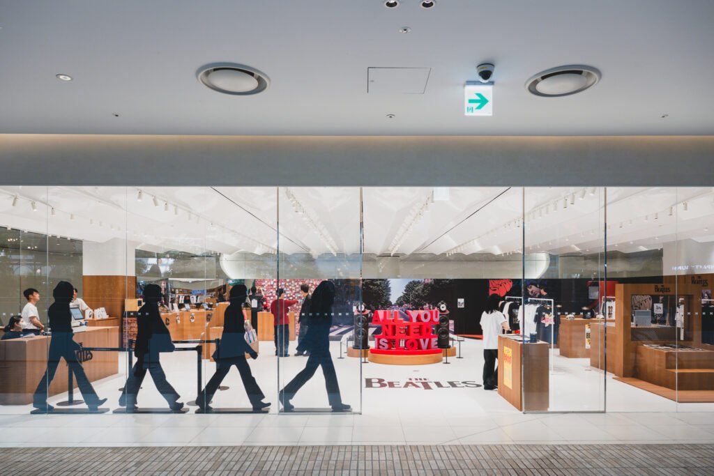Storefront window with the four-figure Abbey Road crosswalk silhouette cutout visible through the glass