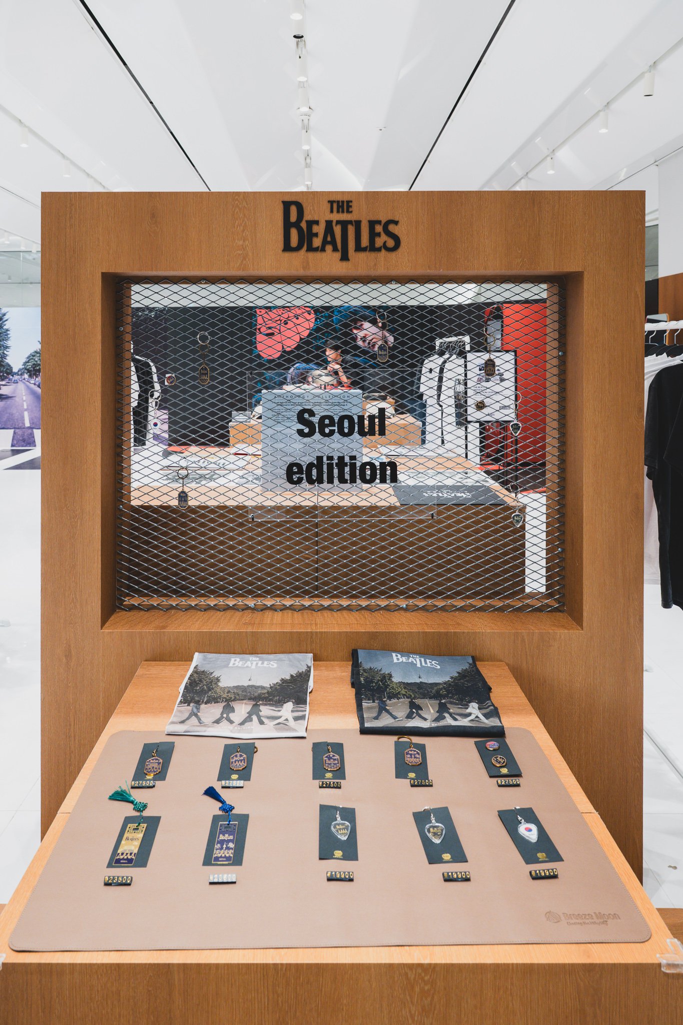 Seoul Edition display case with two Abbey Road-print scarves