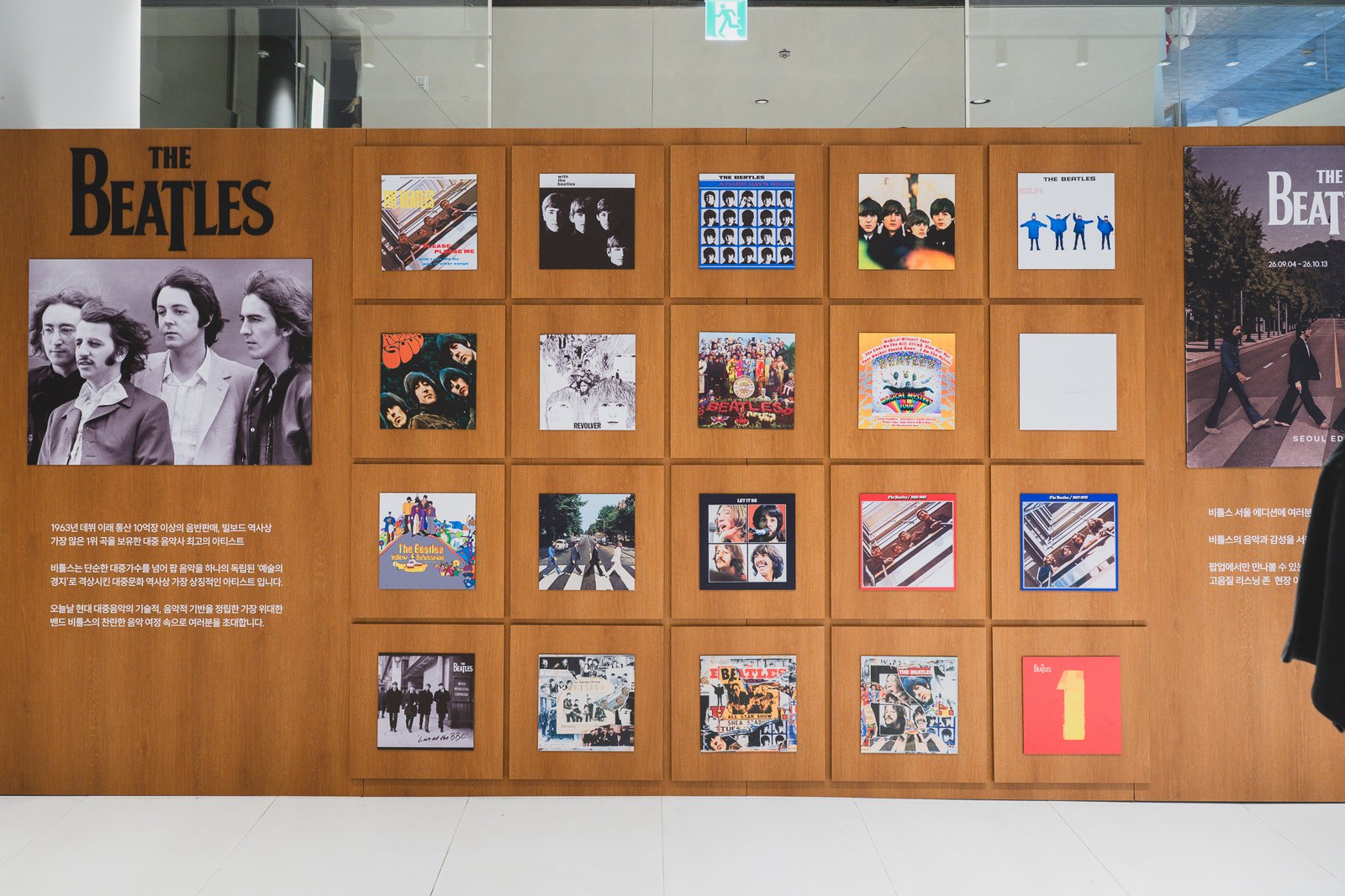 Wall of album covers spanning The Beatles' full discography, with text noting over 1 billion records sold since their 1963 debut