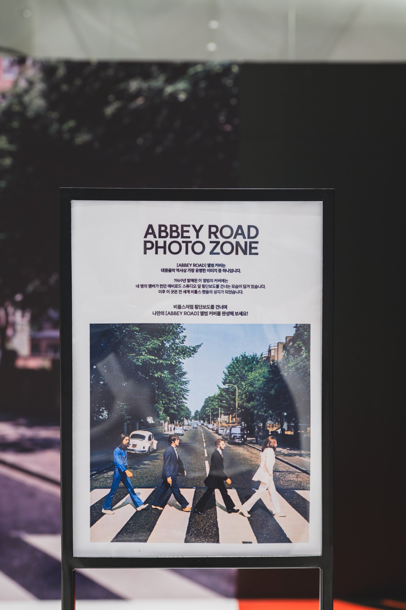 Sign reading "Abbey Road Photo Zone" with instructions and cover art explanation