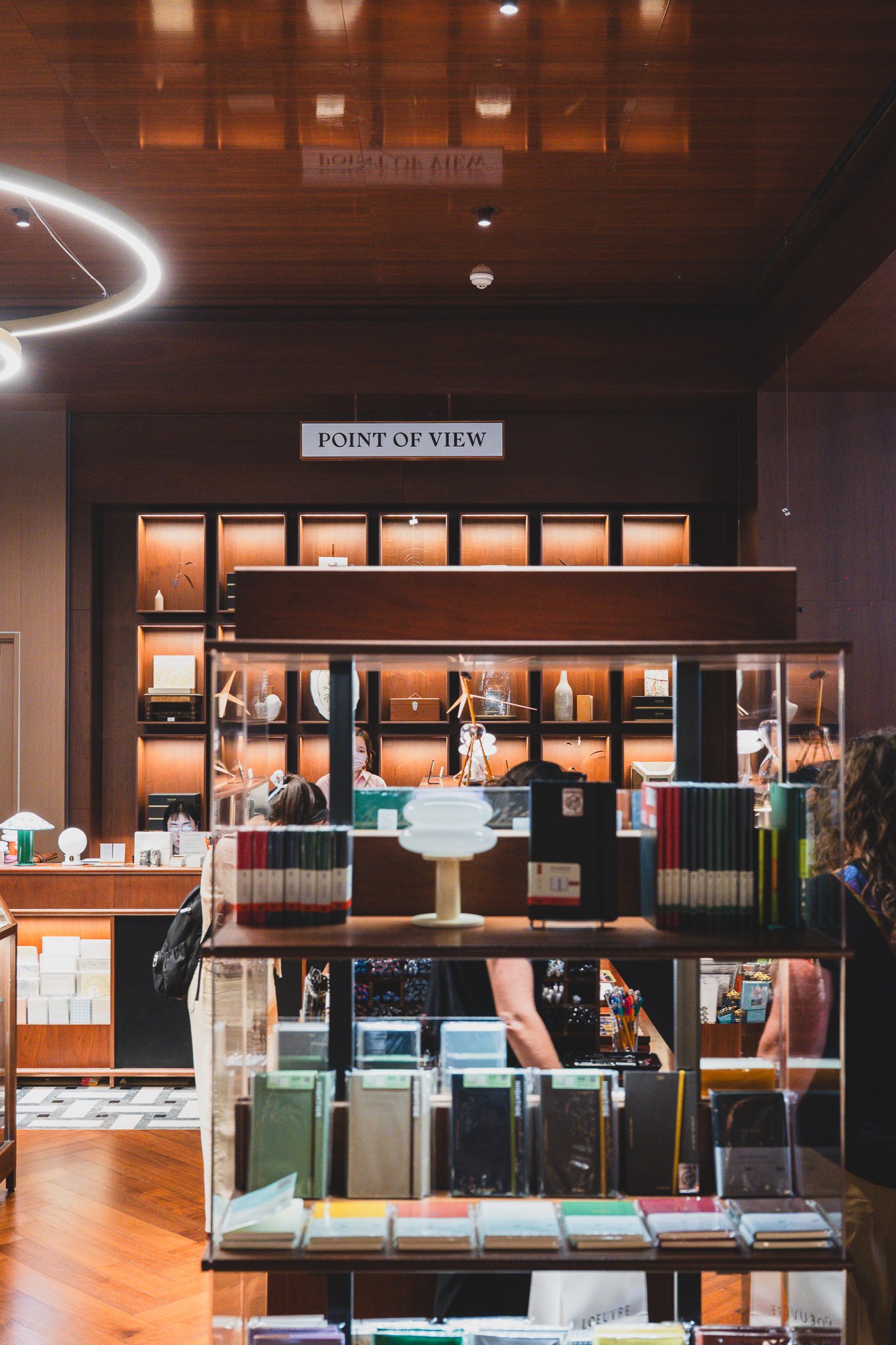 Wood-paneled wall with the "POINT OF VIEW" sign above a lit display case