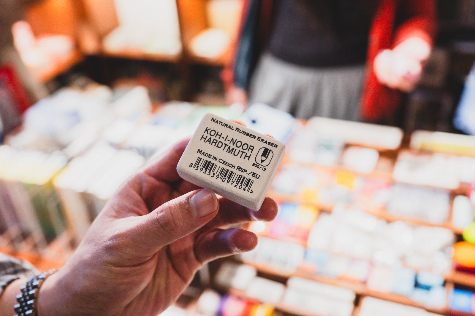 Hand holding a Koh-i-noor Hardtmuth natural rubber eraser, "Made in Czech Rep." visible