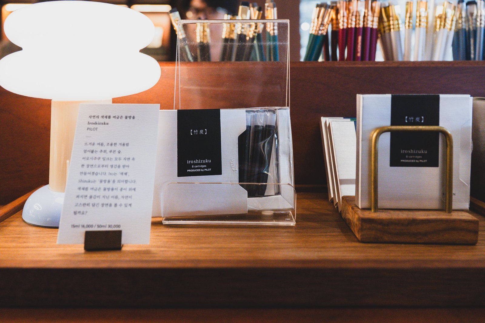 Pilot Iroshizuku ink cartridges displayed under lighting next to an introduction card
