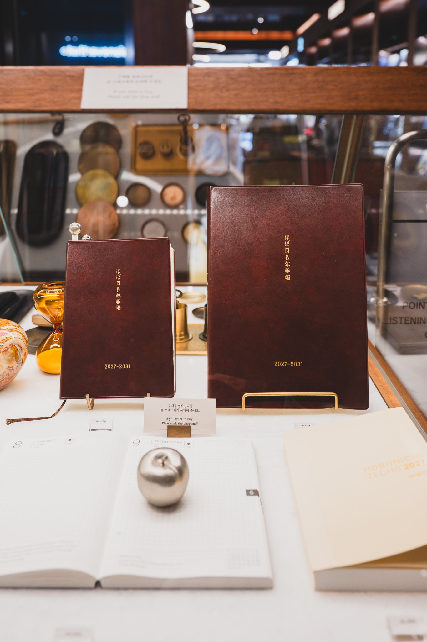 Wine-colored leather-bound Hobonichi 5-Year Techo (2027–2031), shown in both small and large sizes