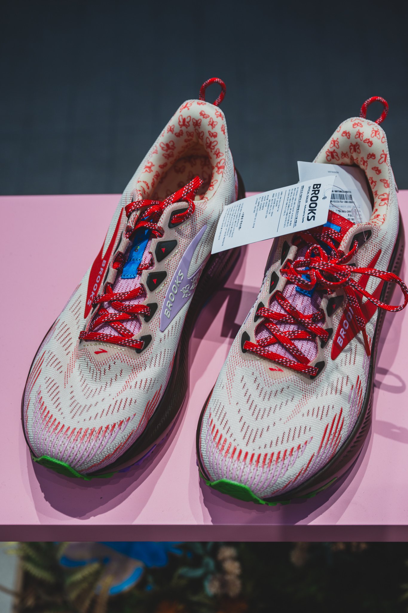 Top-down view of the same shoe showing a butterfly-print lining and red lace detail