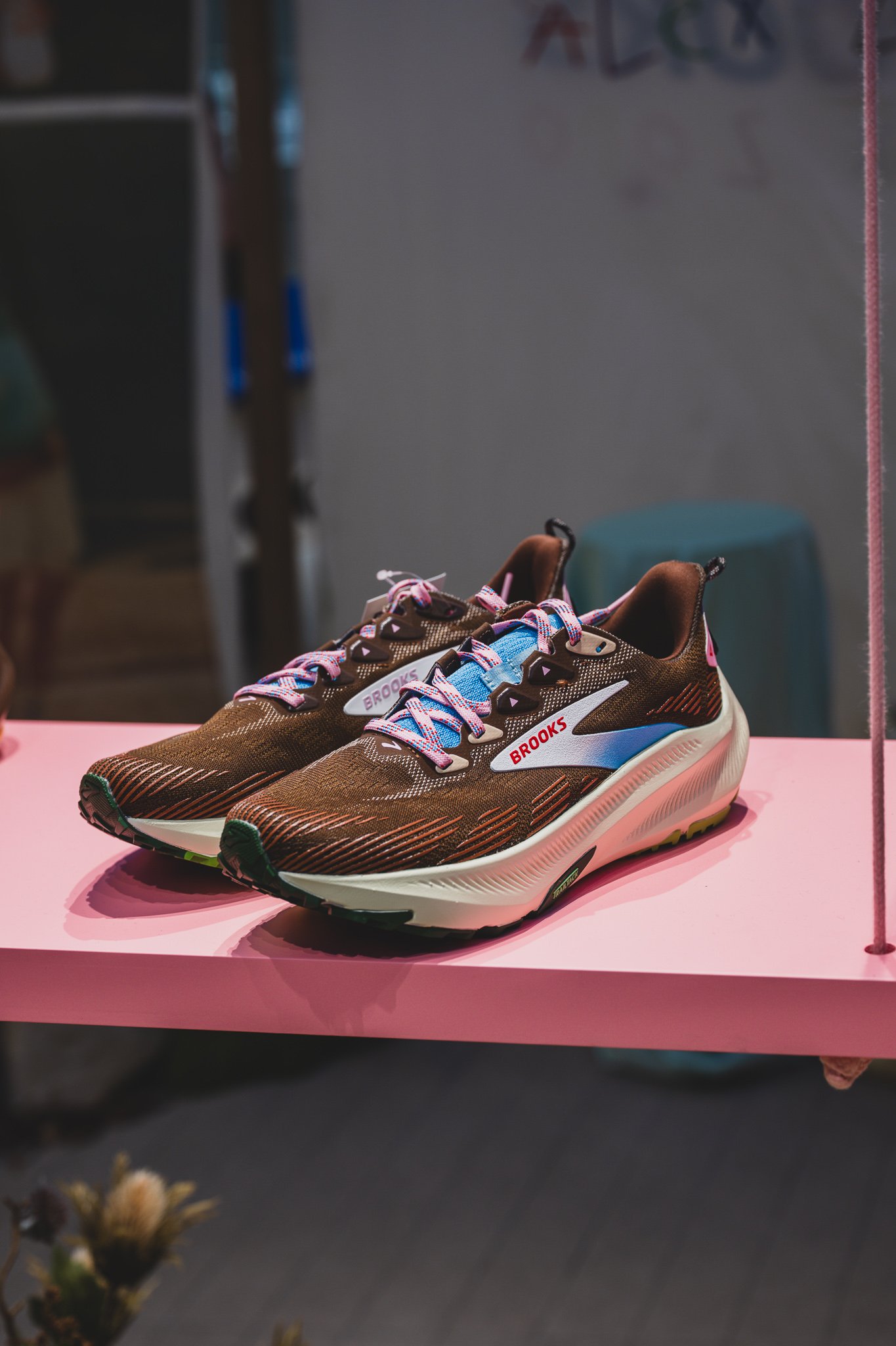 Ghost Trail shoe in brown with sky-blue laces and pink accents