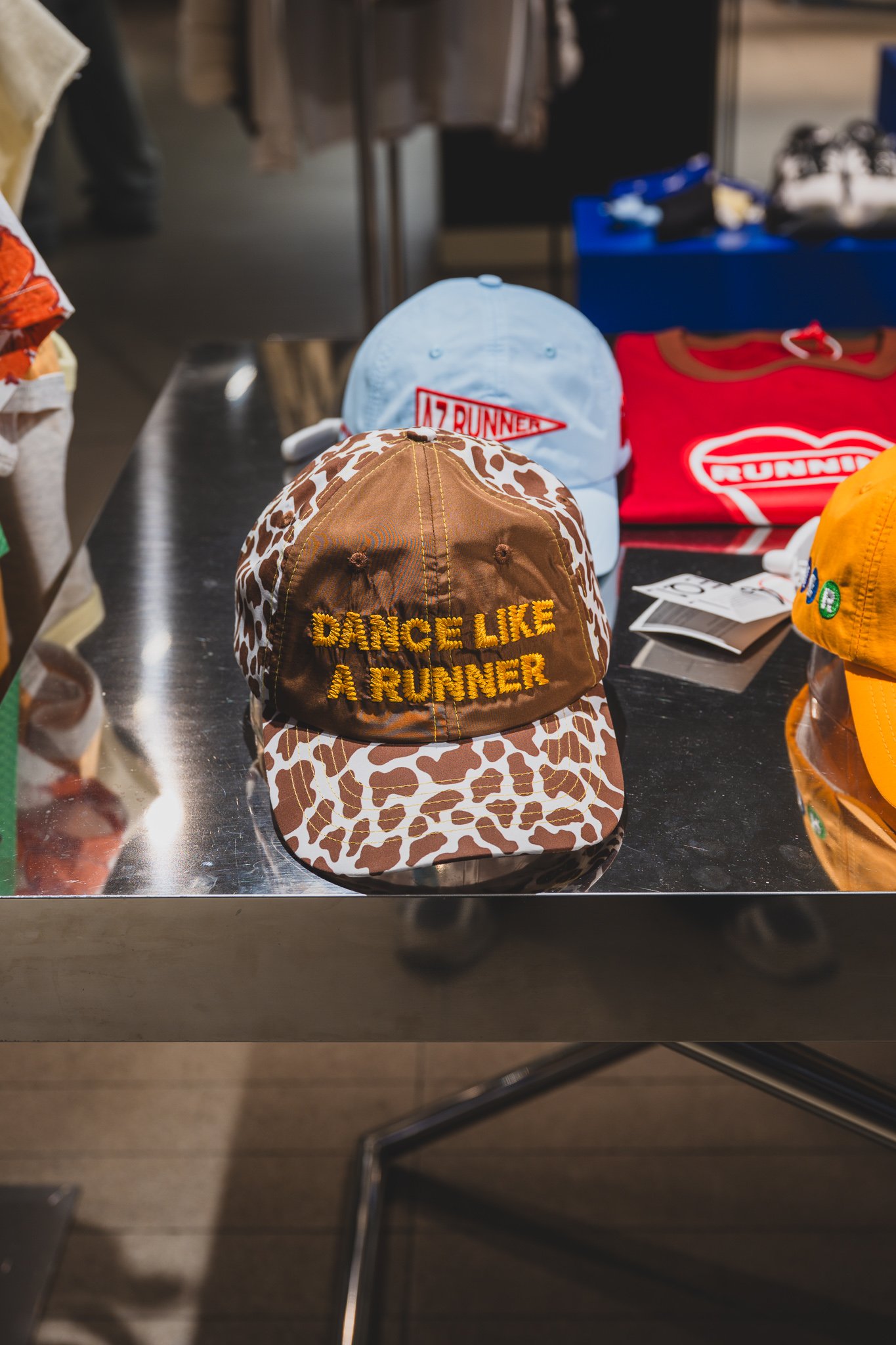 Brown leopard-print cap embroidered with "DANCE LIKE A RUNNER"