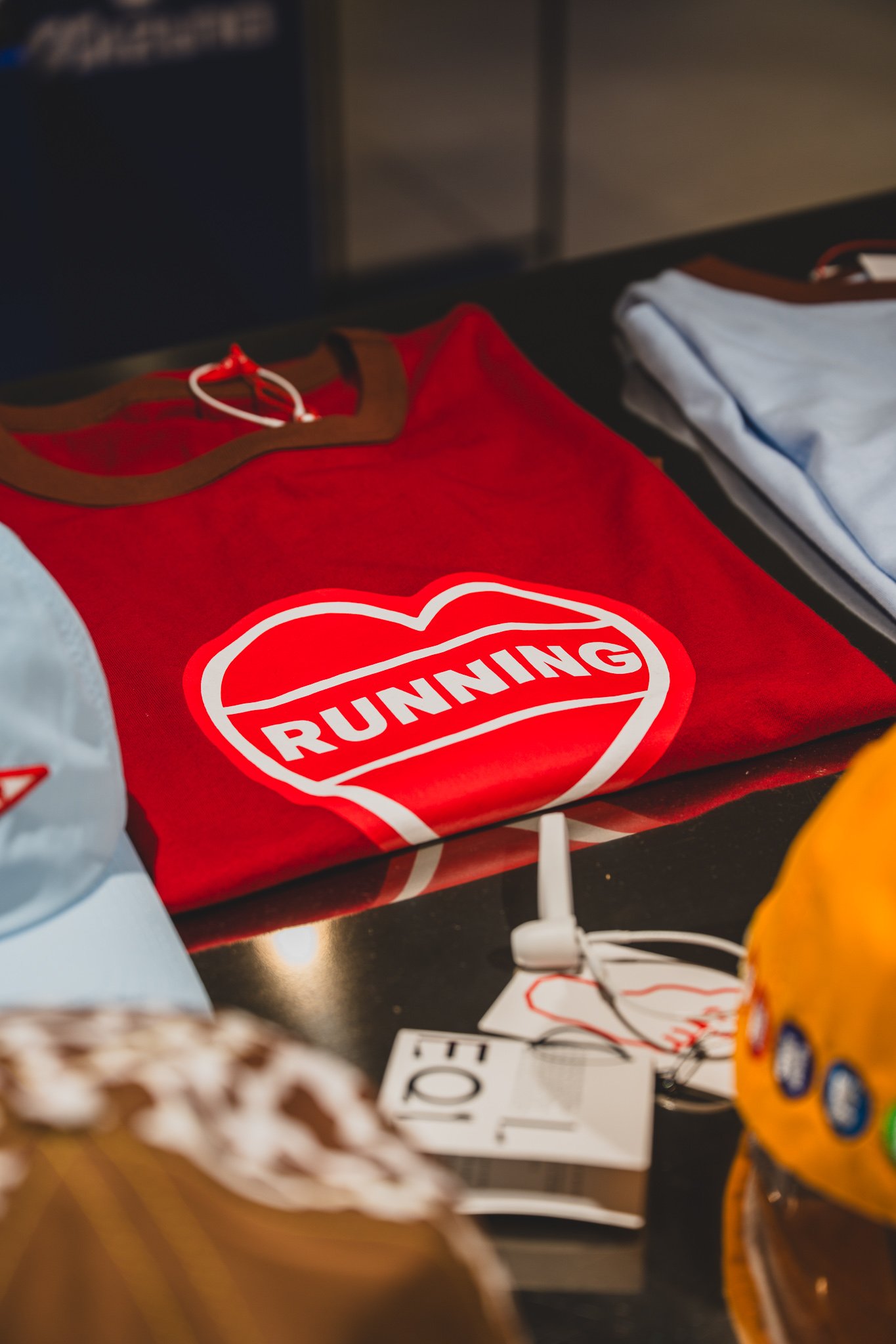 Red t-shirt with a heart-shaped logo reading "RUNNING"