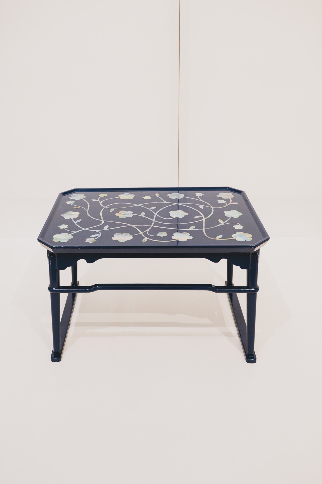 ORION table by Stefano Giovannoni with mother-of-pearl floral inlay on navy lacquer