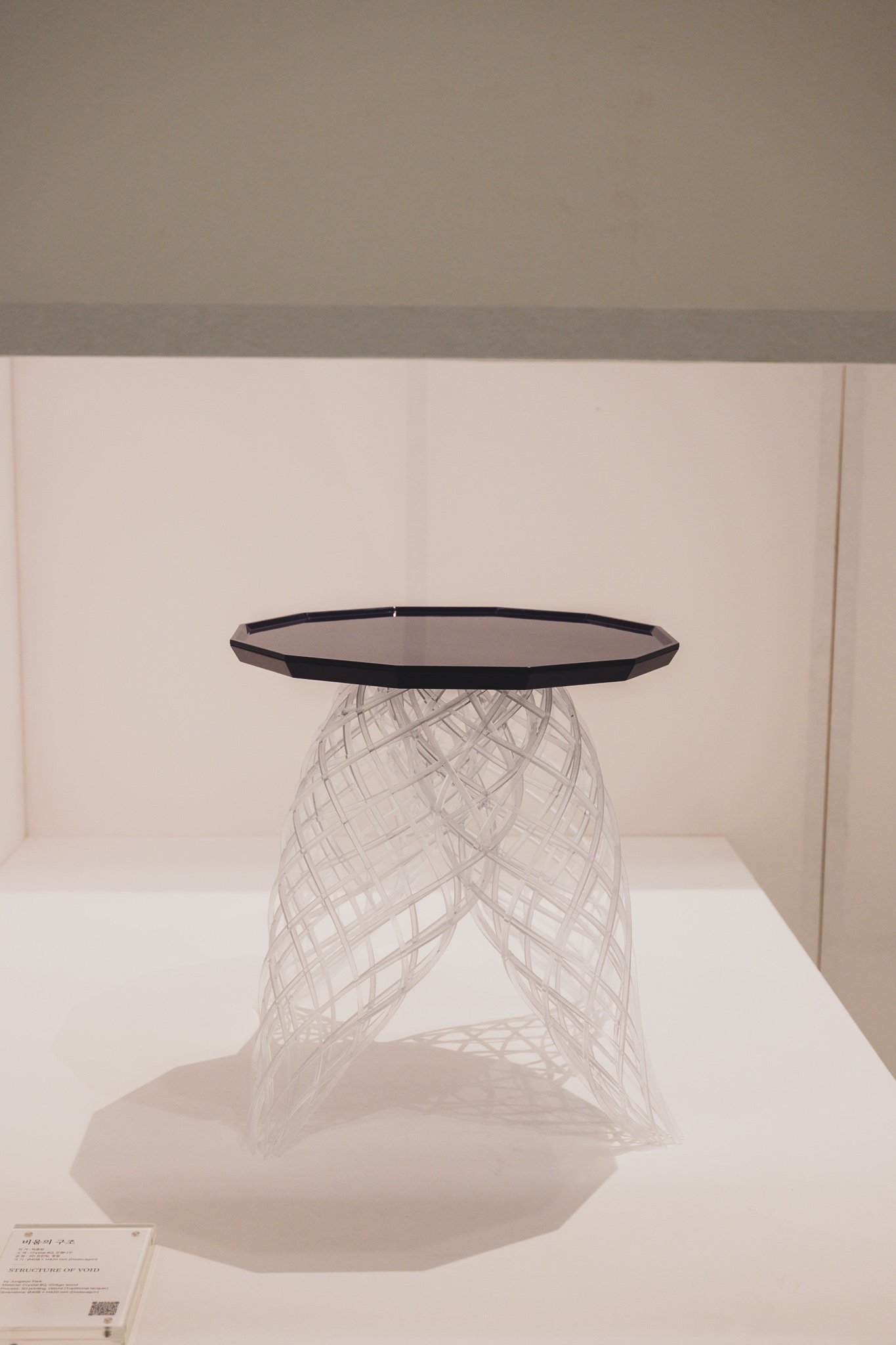 Structure of Void table with smoky crystal top on spiraling transparent 3D-printed legs