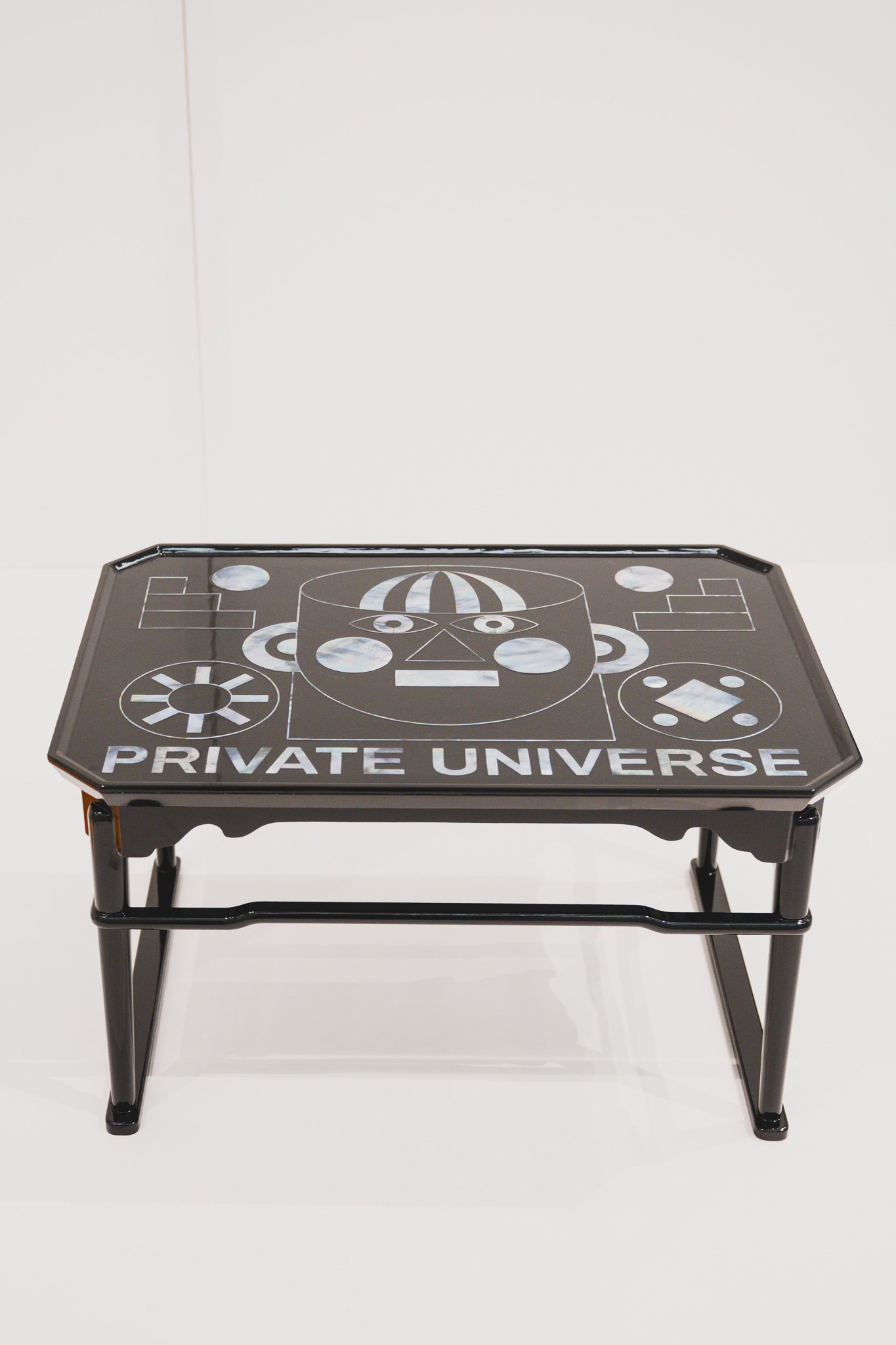 Private Universe table with pop-art mother-of-pearl robot face design