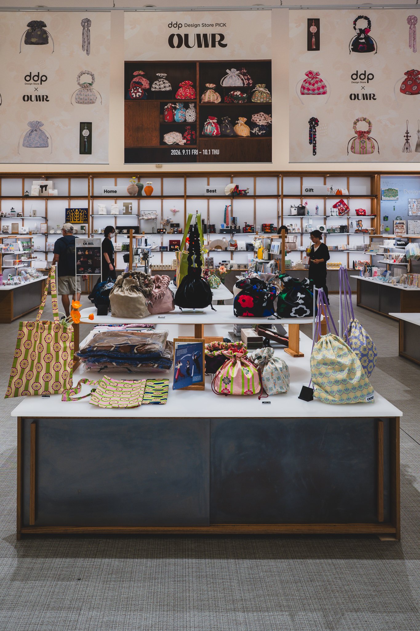 OUWR pop-up banner at the store entrance with pouch, scrunchie, and daeng patterns, running Sept 11–Oct 1