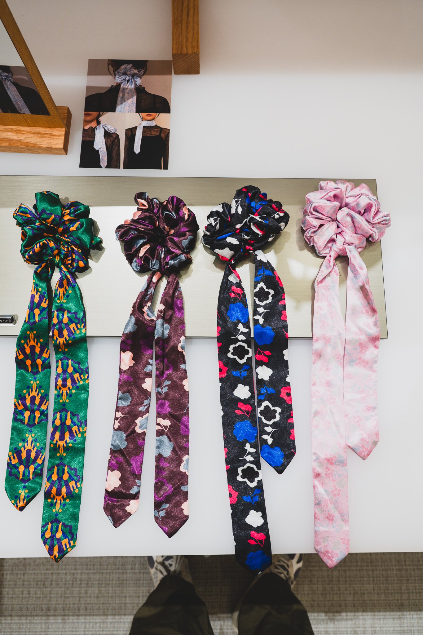 Daeng scrunchies in multiple colorways — green, gray, ivory, blue — hanging together