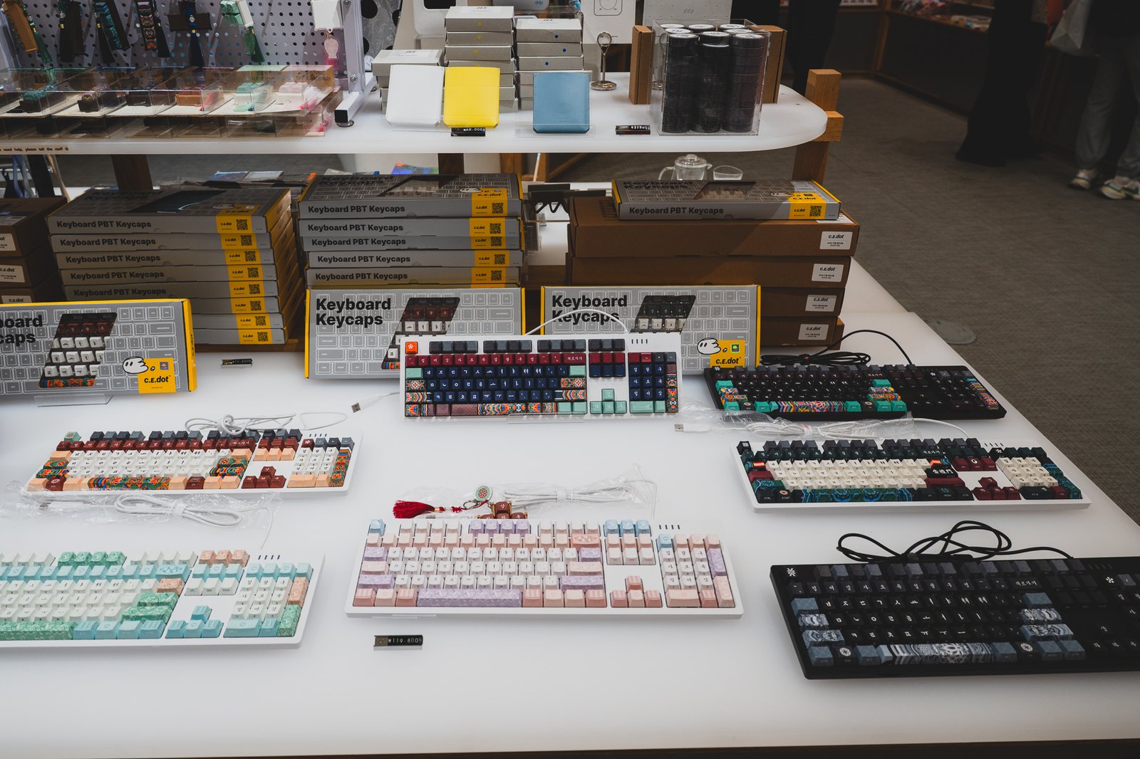 Table of c.e.dot Korean keycap sets in boxed packaging