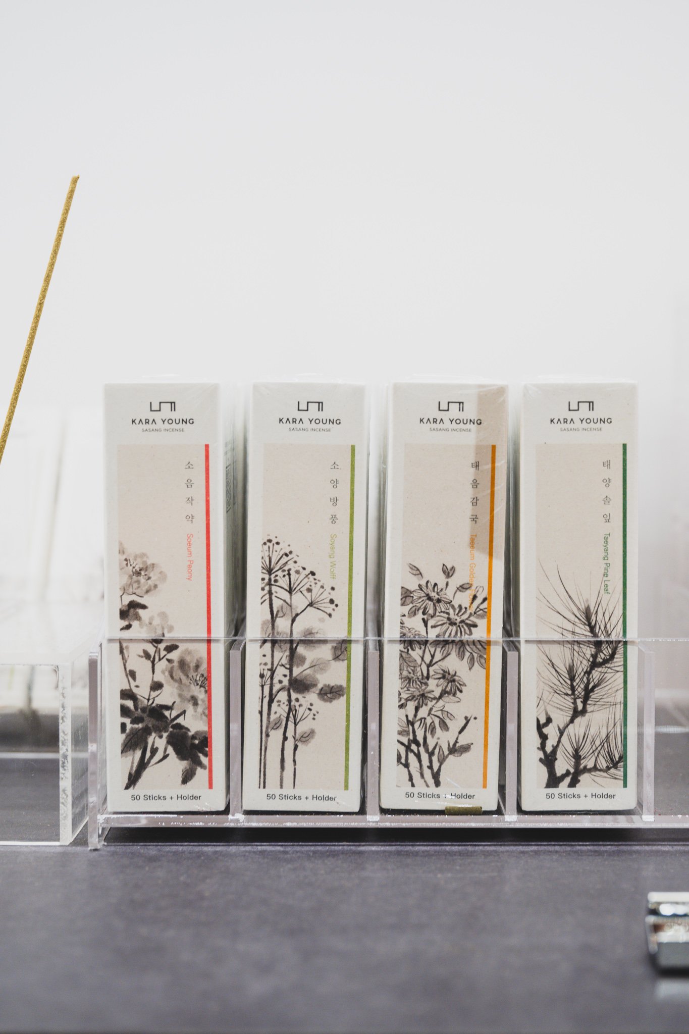 Kara Young sasang-constitution incense boxes in four scents with an incense stick burning