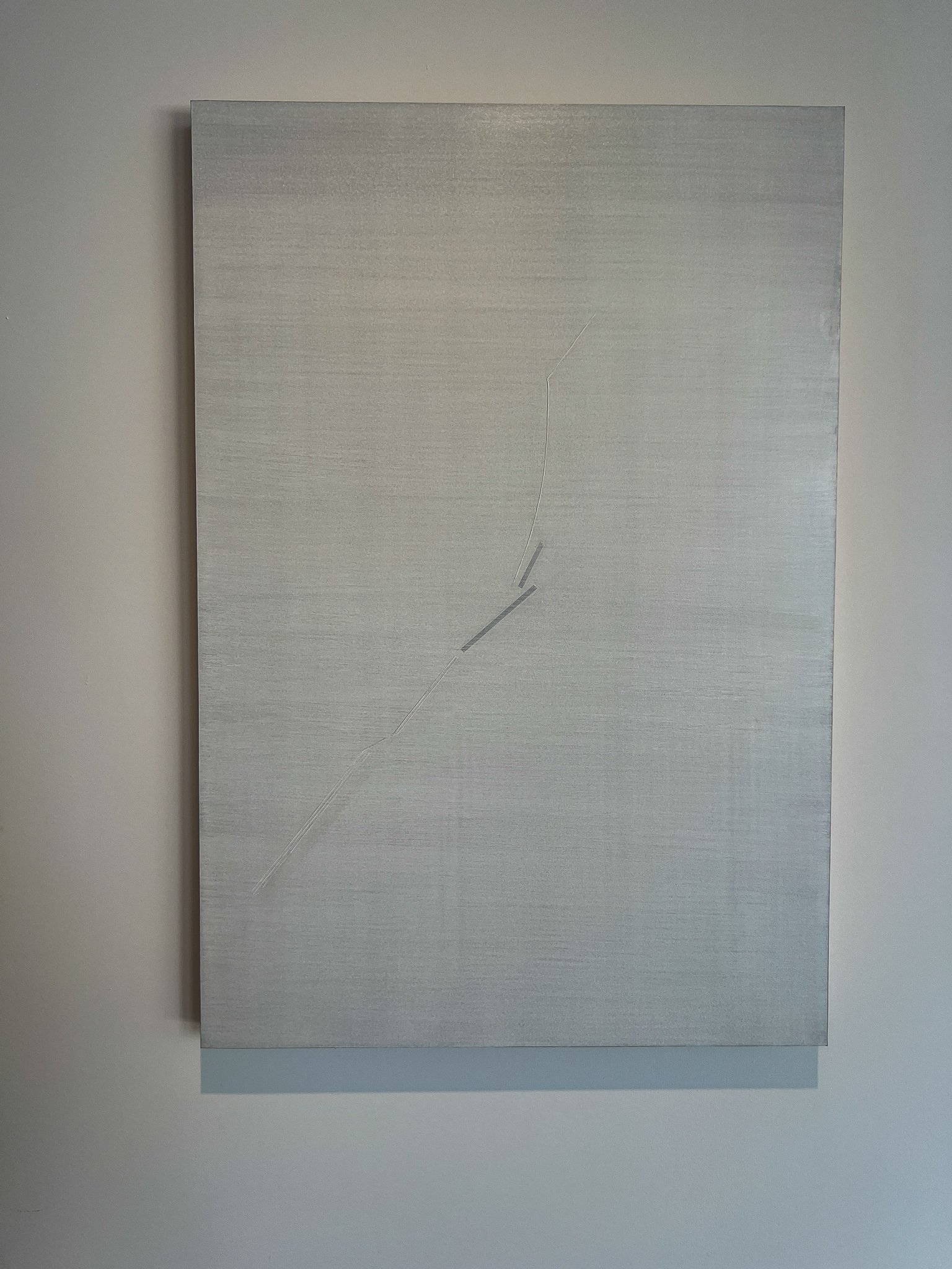Huong Dodinh, X.K.N.31, 2025–2026 — the new work she painted for this exhibition, a diagonal line cutting across a pale, layered surface